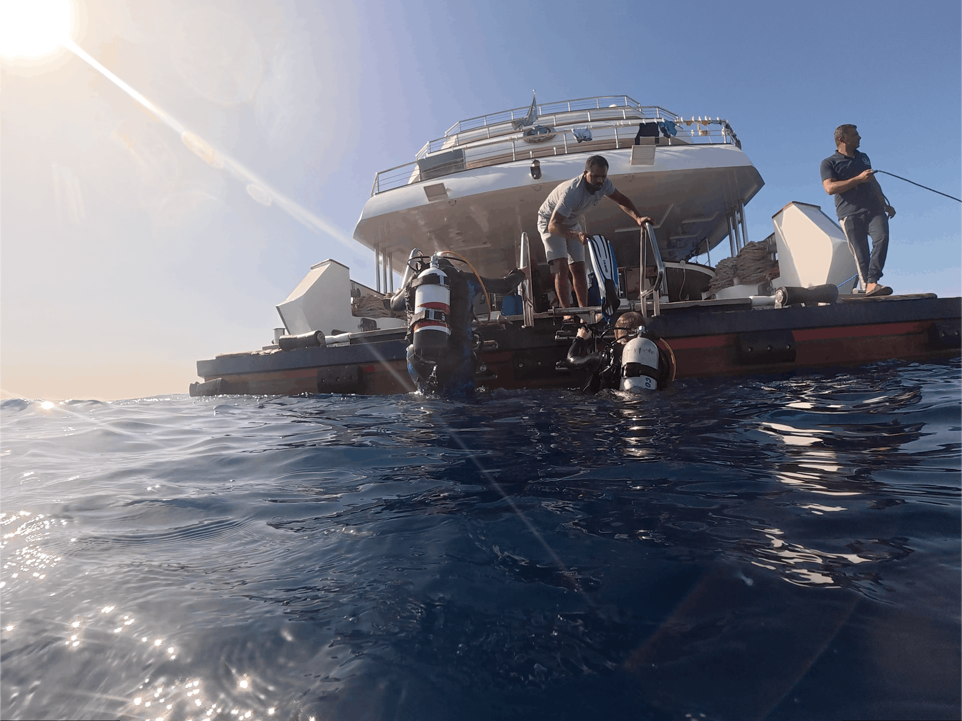 Diver entering the water with crew assistance aboard the All Star Scuba Scene, Red Sea, Egypt
