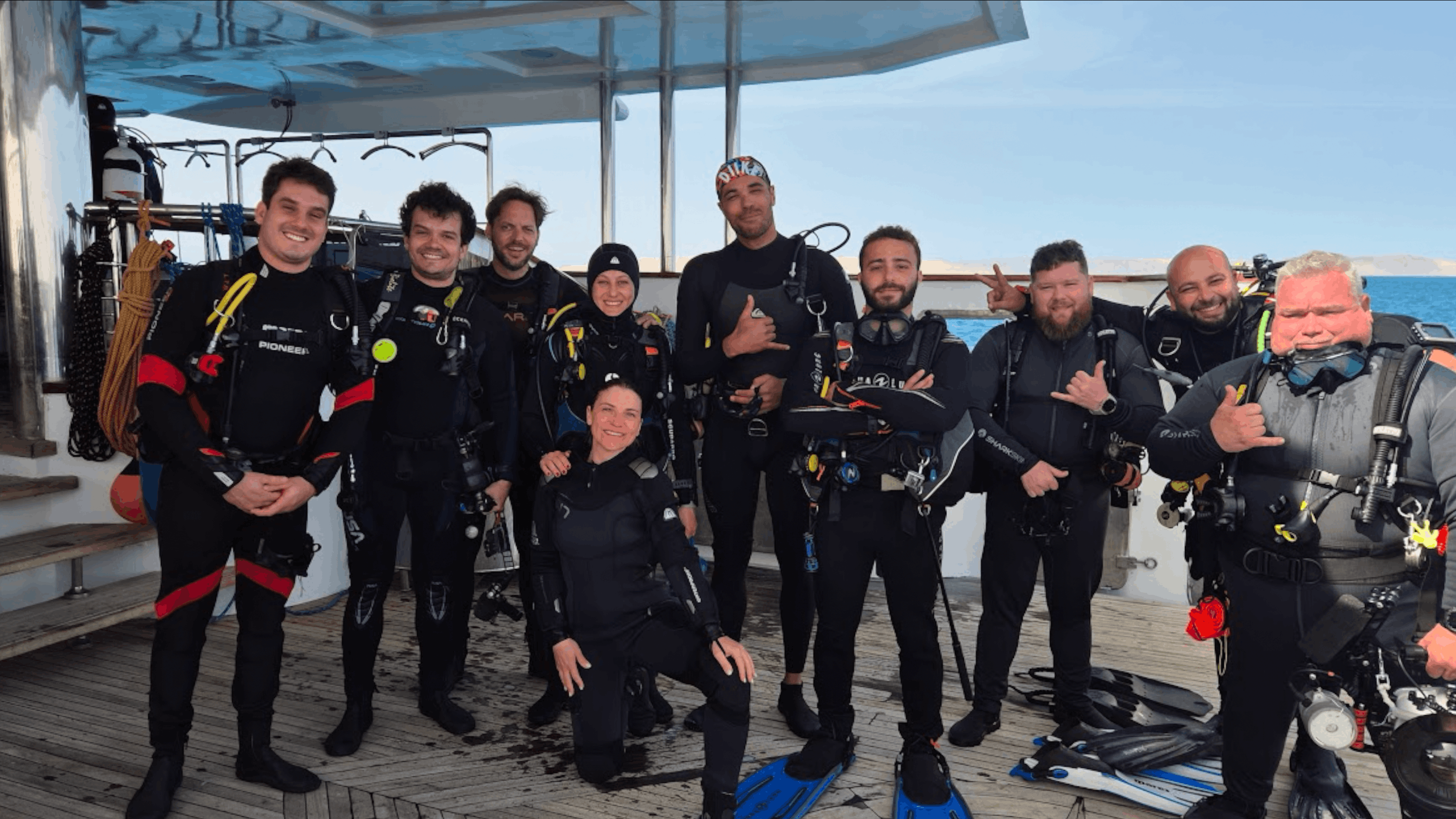 Dive group posing on deck aboard the All Star Scuba Scene, Red Sea, Egypt