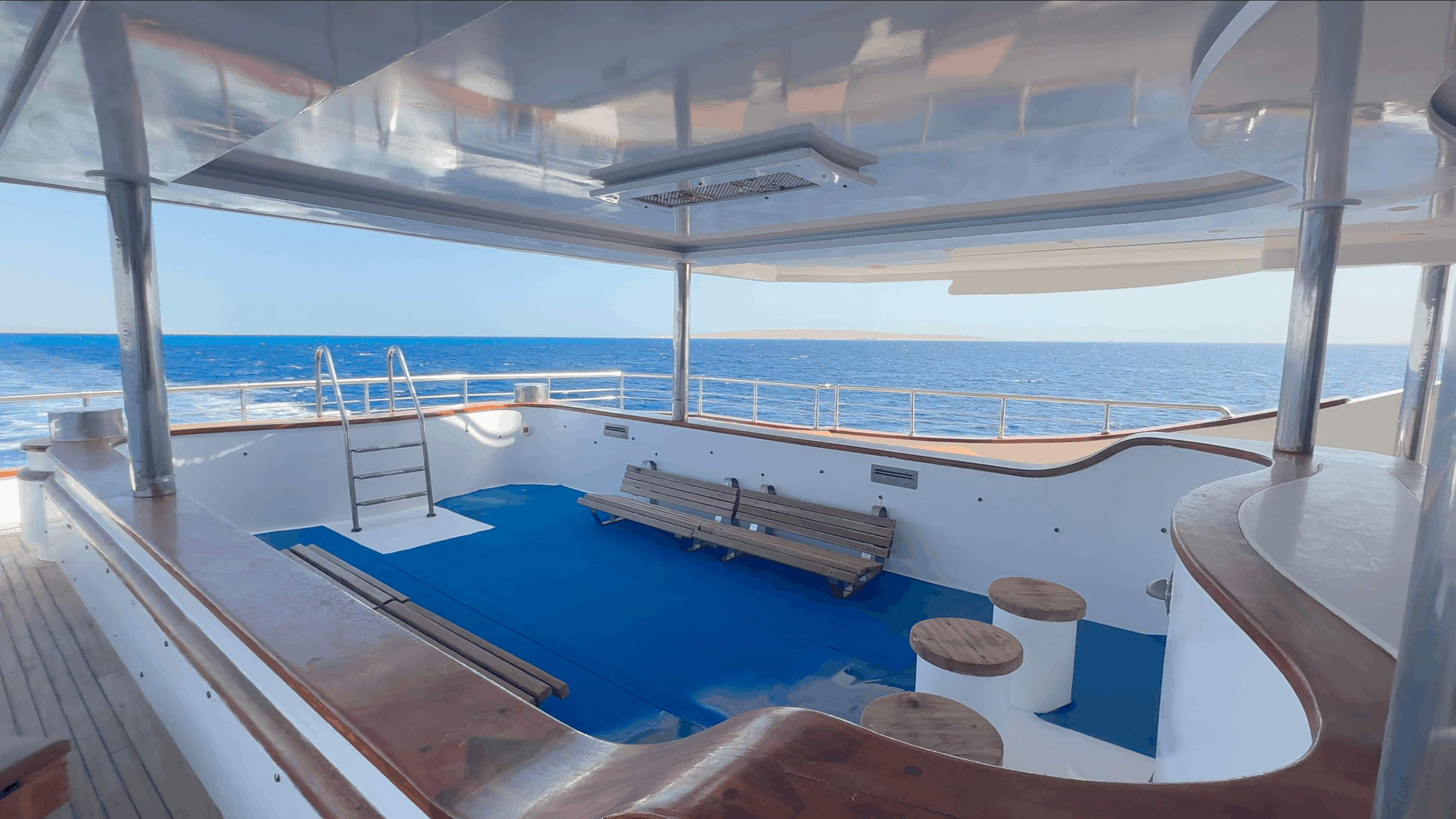 Empty sundeck pool and lounge area aboard the All Star Scuba Scene, Red Sea, Egypt