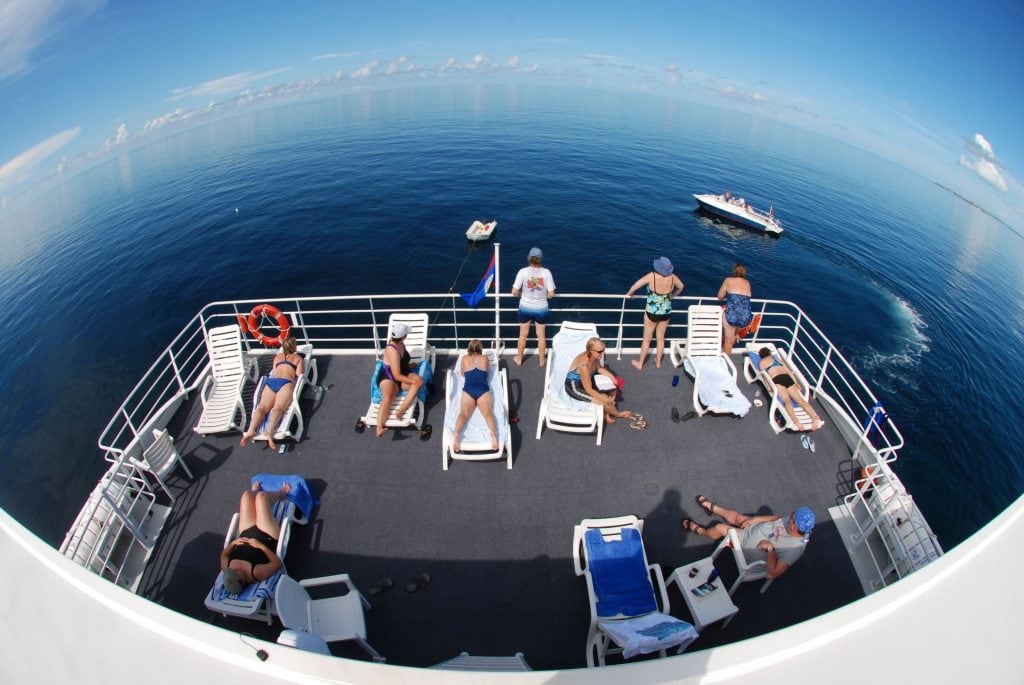 Guests relaxing on the Aqua Cat sundeck between dives