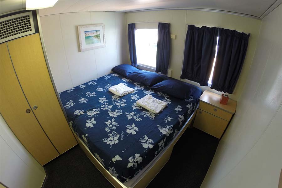 A queen-bed cabin aboard the Aqua Cat