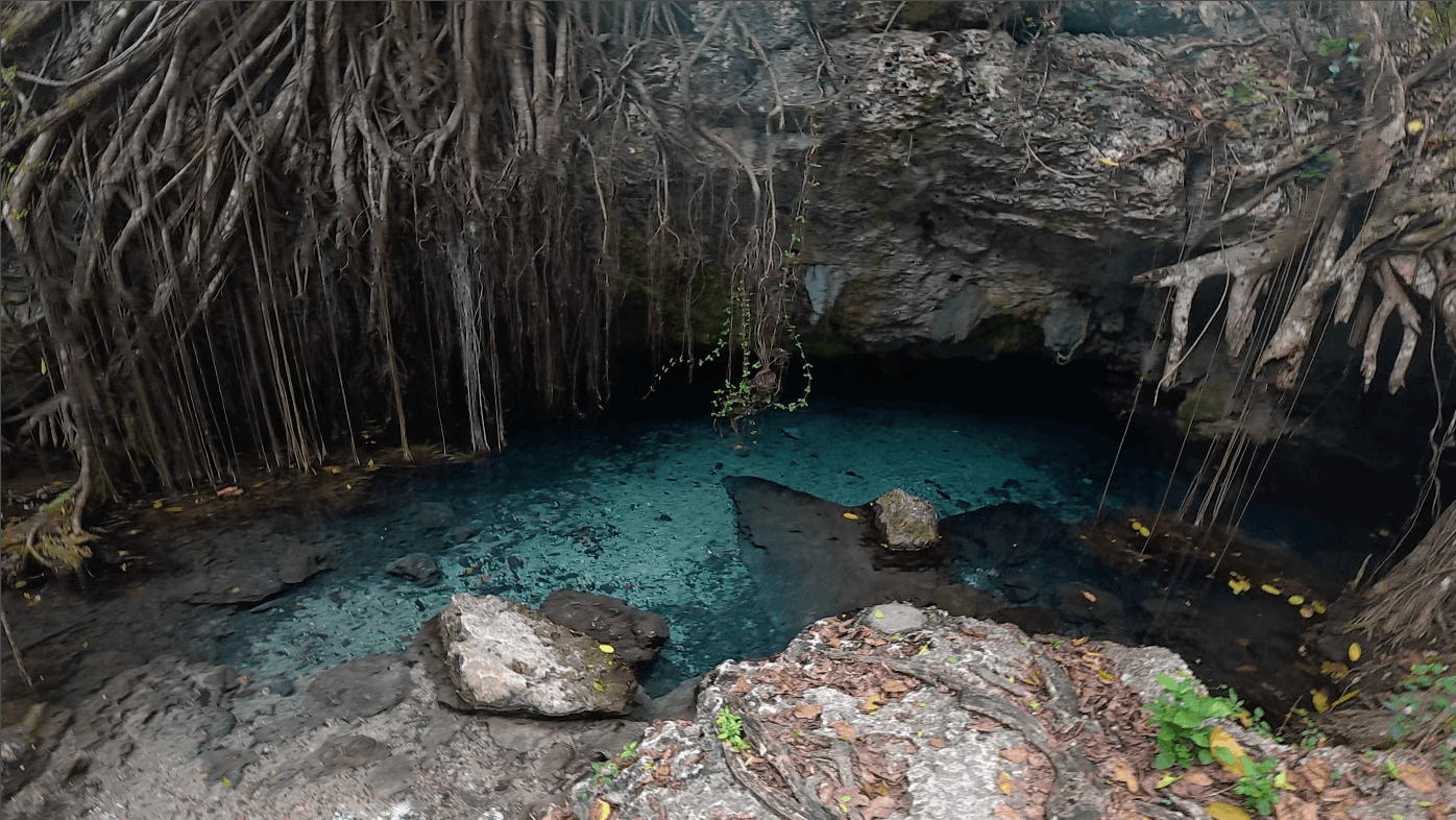 Turquoise freshwater pool at the entrance to Cueva Padre Nuestro, Dominican Republic