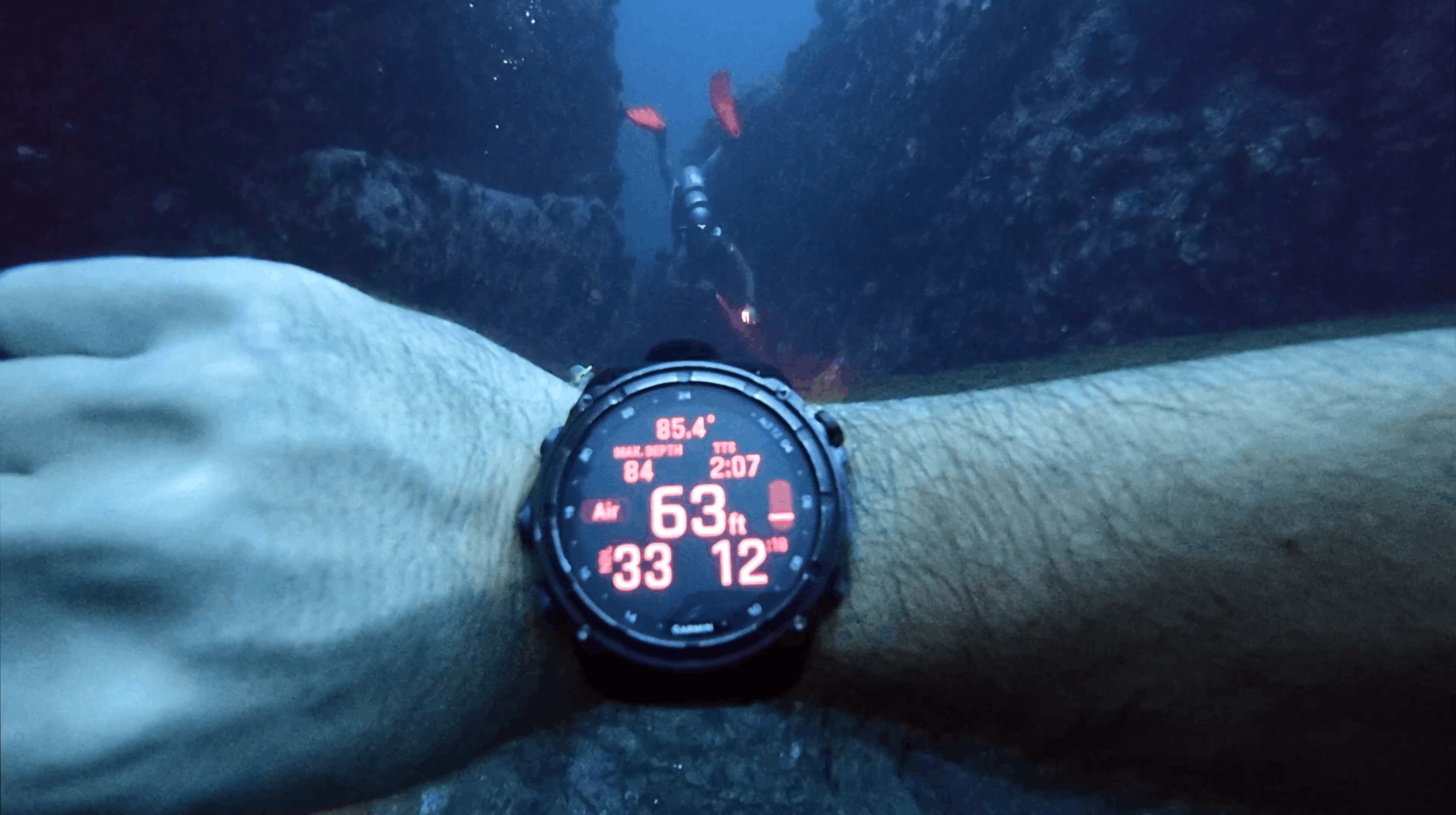 Garmin Descent MK3i reading 63 feet at Chumphon Pinnacle, with a diver ahead in the channel