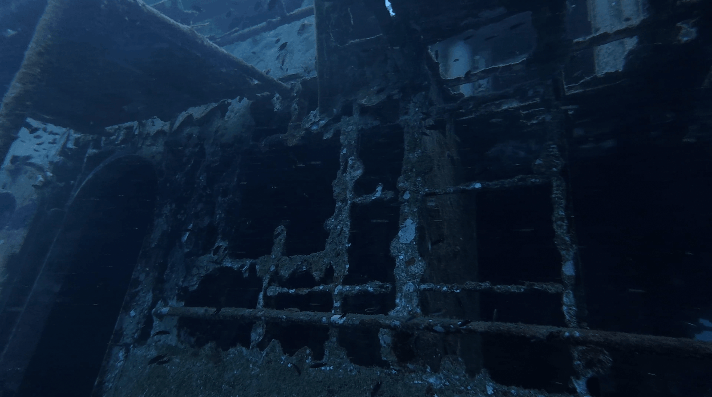 Encrusted superstructure and open window frames on the HTMS Suphairin wreck, Koh Tao