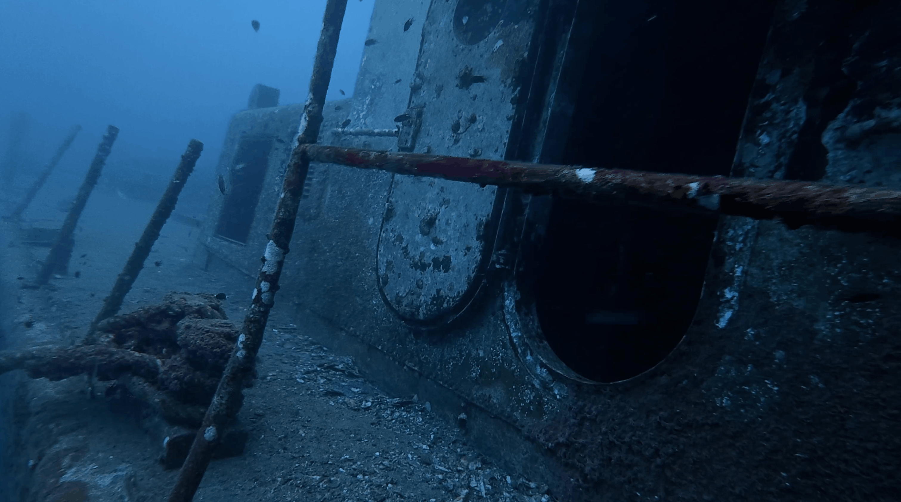 Porthole and railing detail along the hull of the HTMS Suphairin, Koh Tao