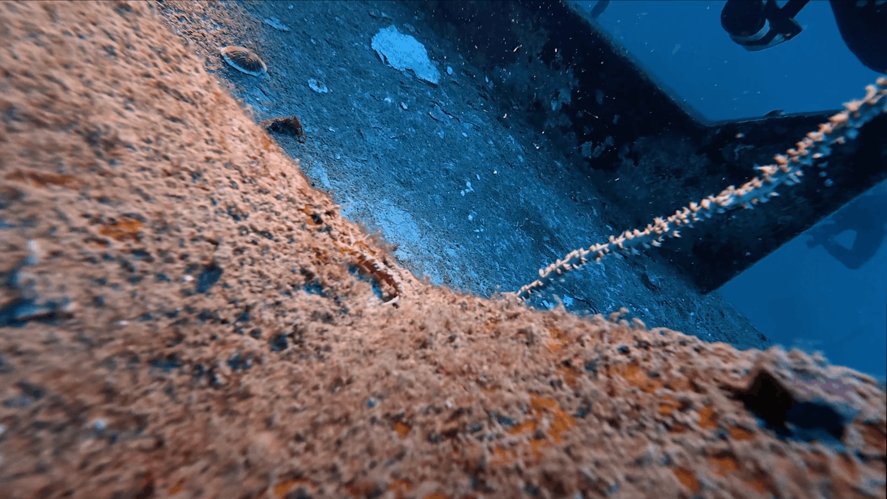 Rust and encrustation spreading across the hull of the HTMS Suphairin, Koh Tao
