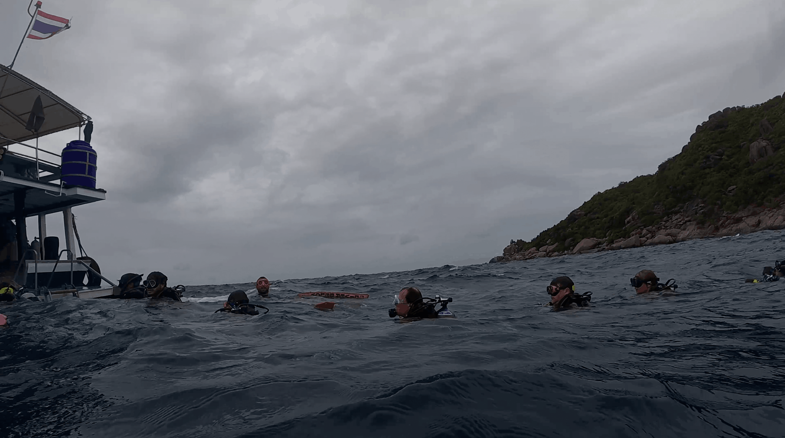 Divers at the surface beside the Big Blue Diving boat at No Name Pinnacle, Koh Tao