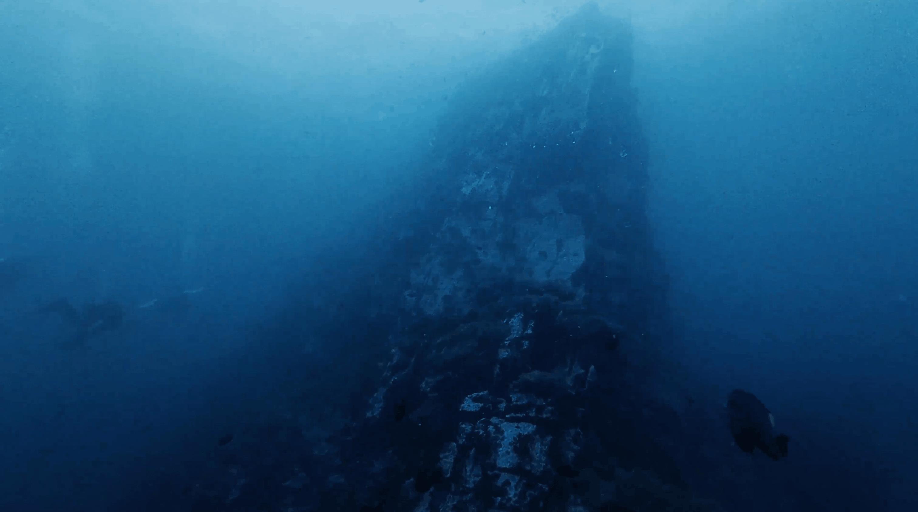 The peak of Southwest Pinnacle seen through the blue, Koh Tao