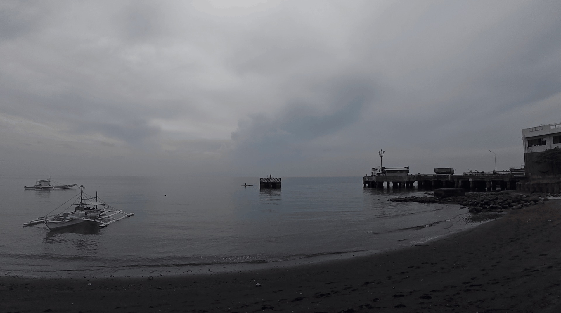 The beach and pier ruins at Dacumi, Dauin, Philippines