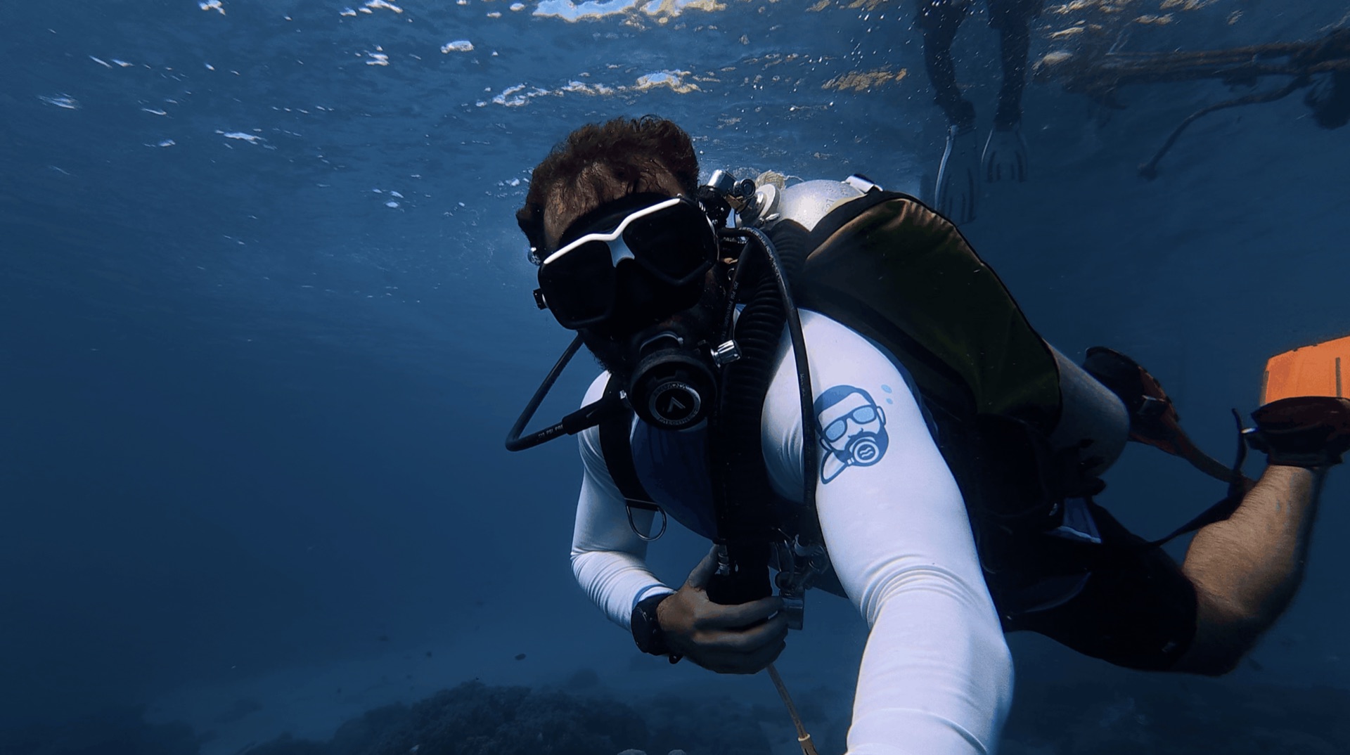 Divemaster Austin descending at Largahan, Apo Island, Philippines