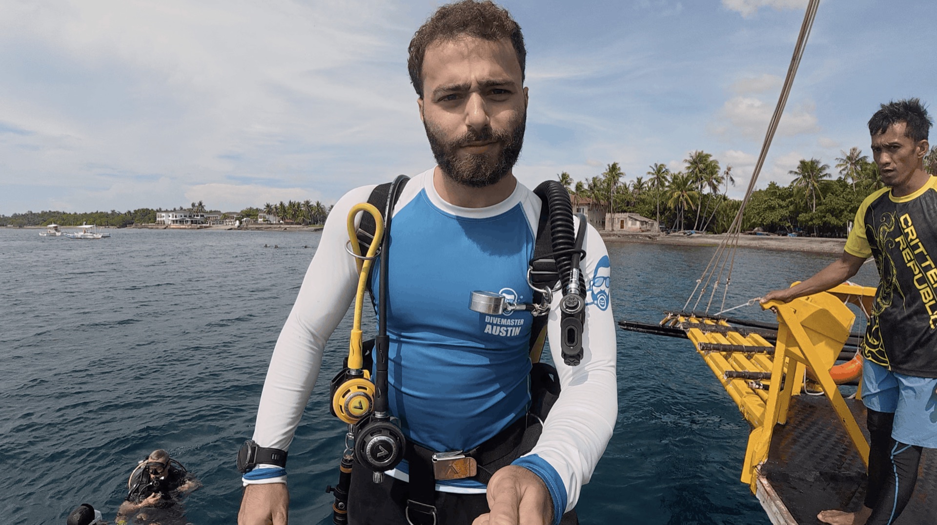 Divemaster Austin in his gear on the boat before the dive at Malatapay, Zamboanguita, Philippines