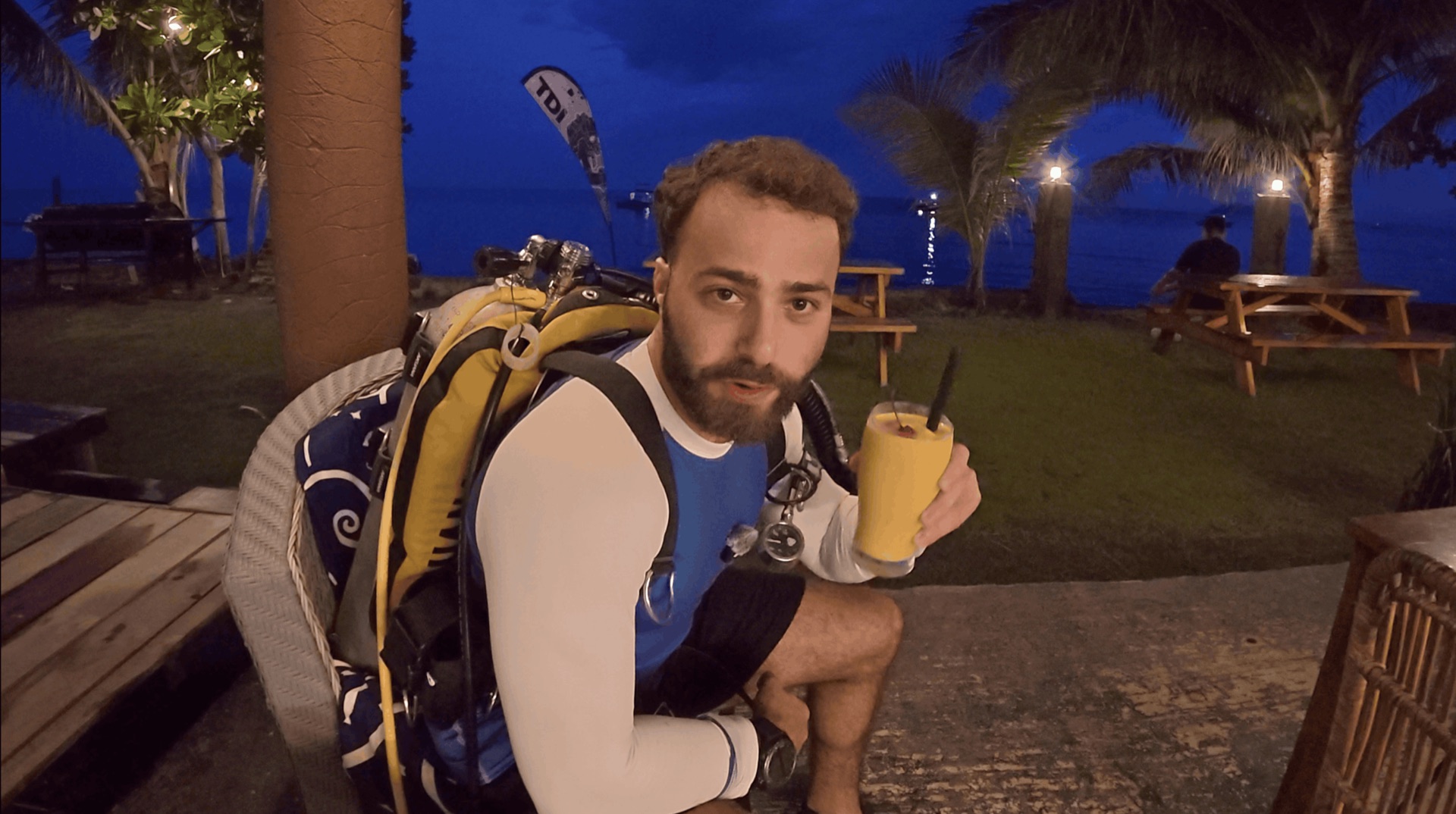 Divemaster Austin in his scuba gear at dusk before the night dive at Critter Republic House Reef, Dauin, Philippines