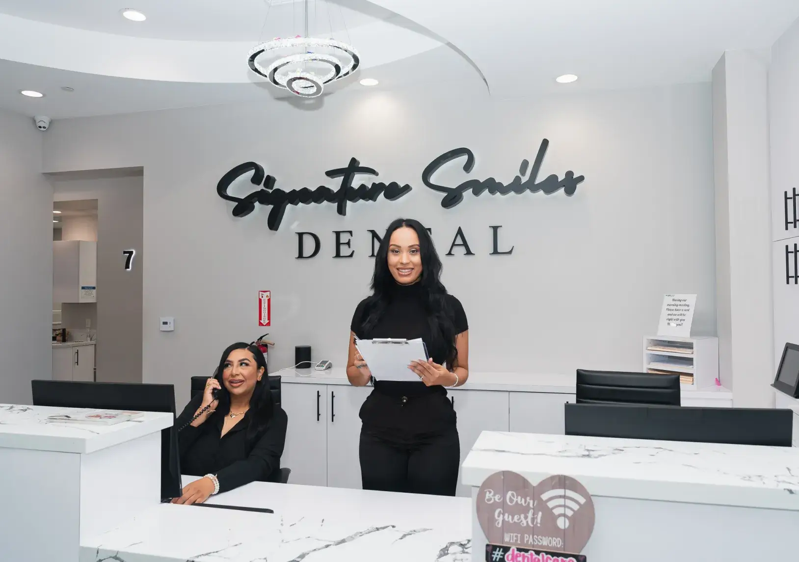 A couple of women standing in front of a counter.