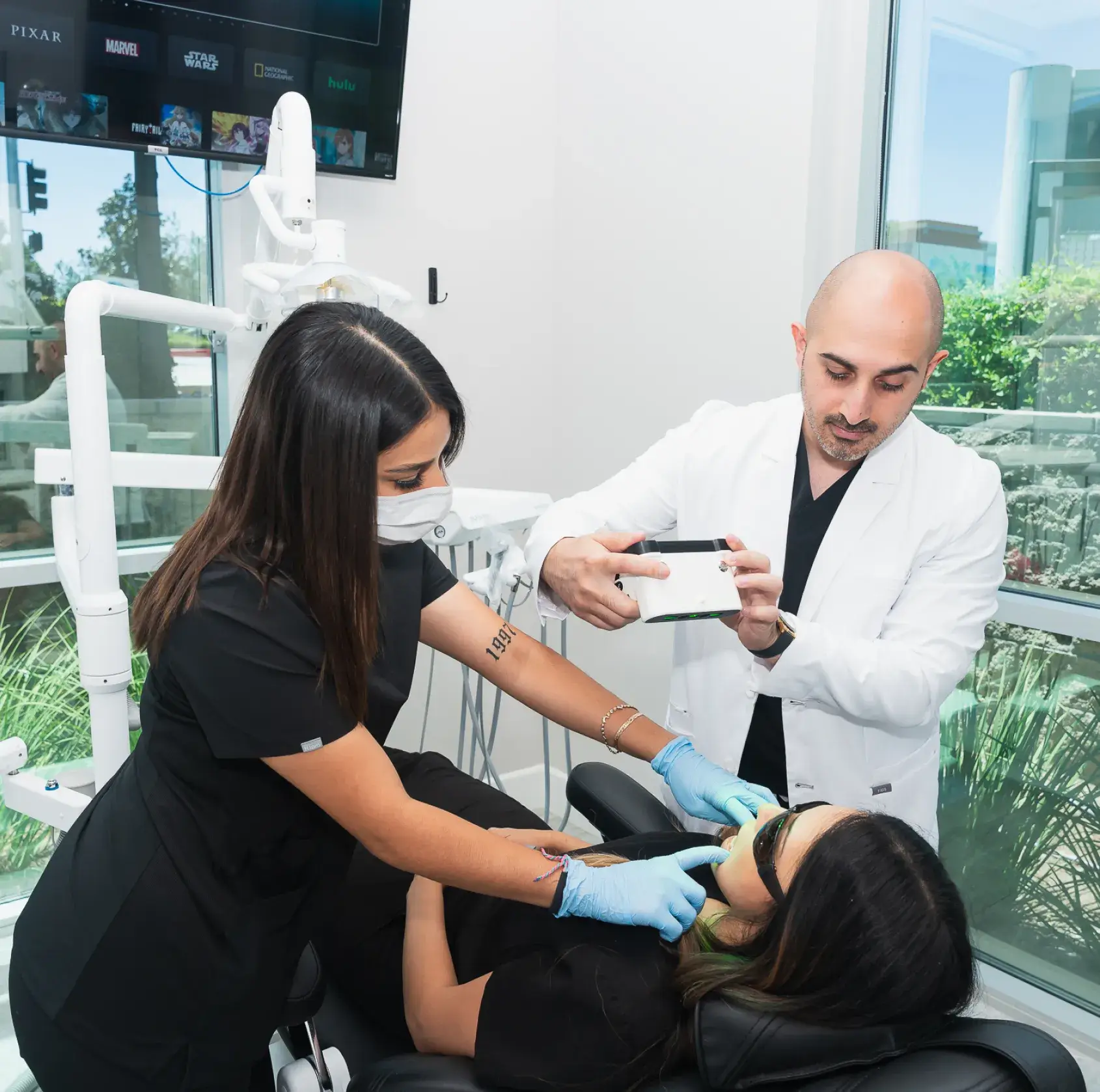 A woman getting her teeth checked by a dentist.