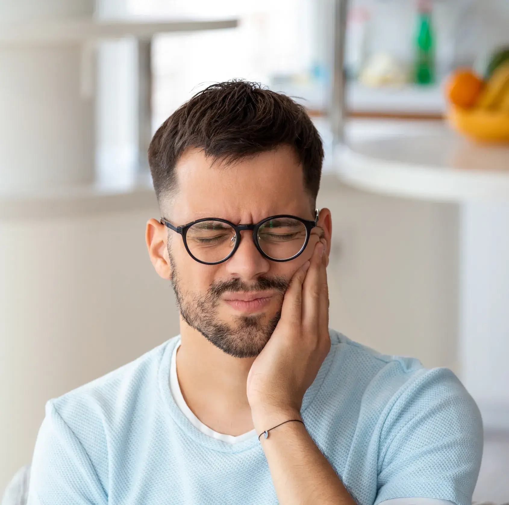 A man with glasses is looking at something.