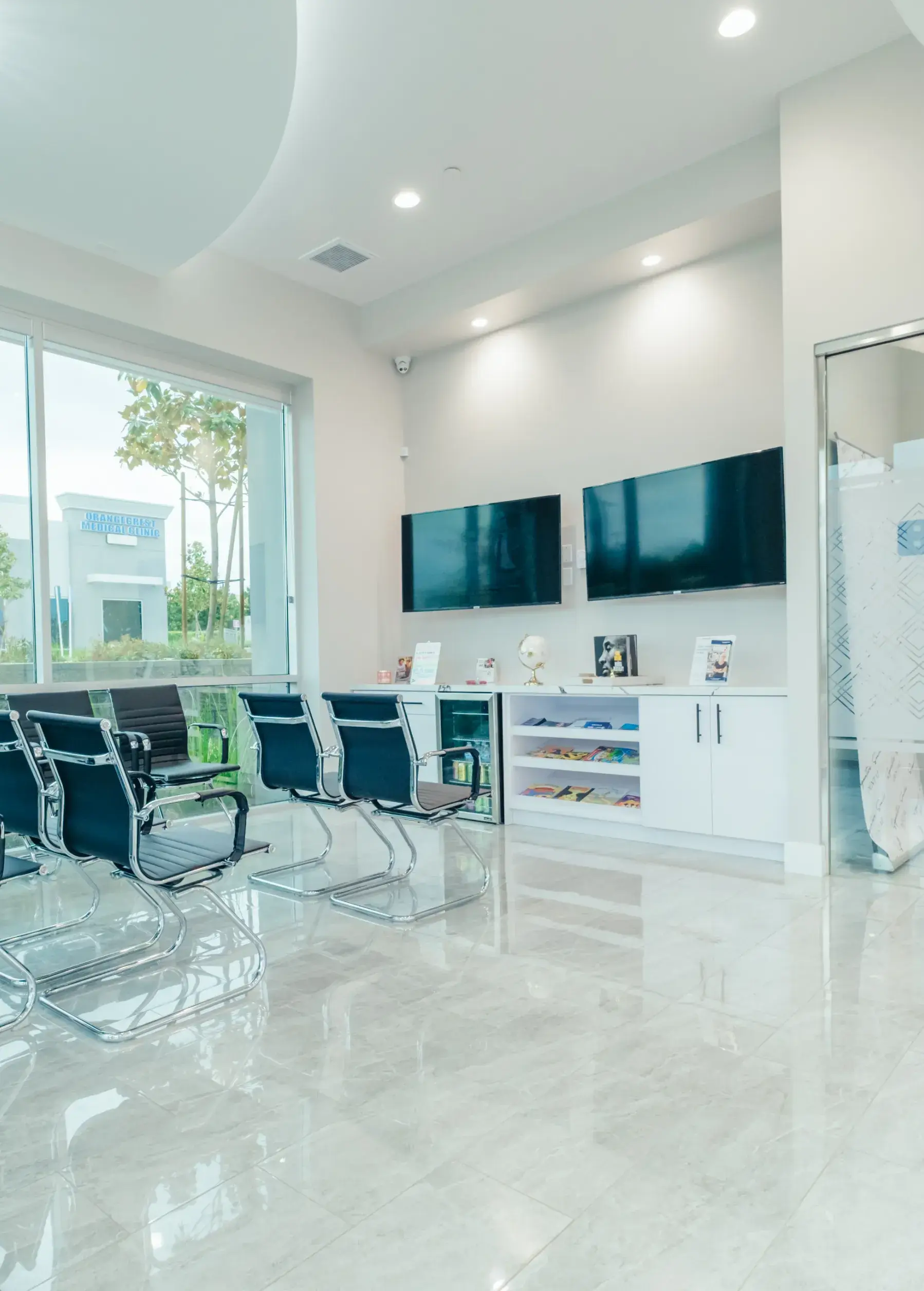 A room with chairs and televisions in it.