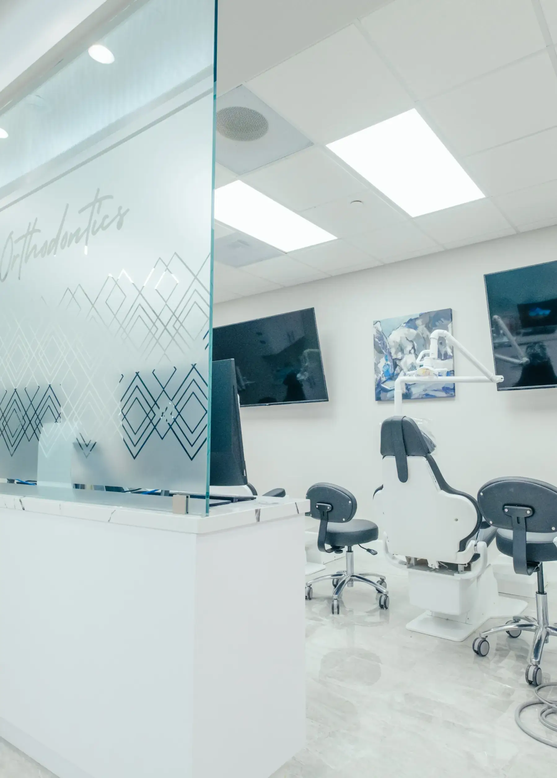 An office with a glass wall and chairs.