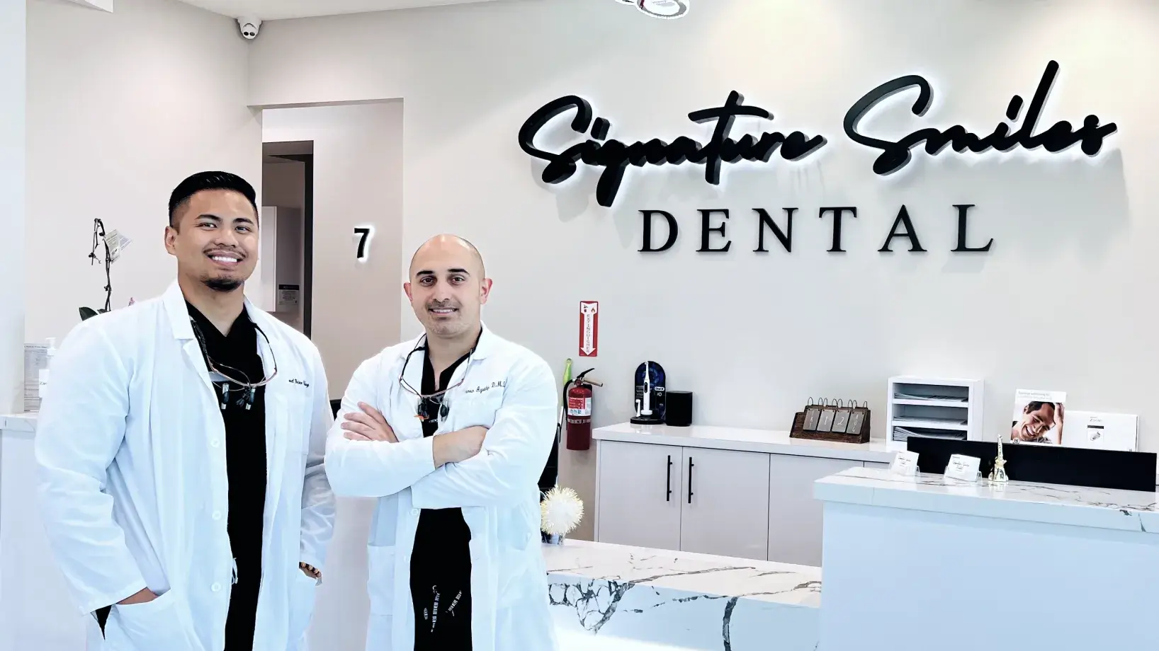 Two men standing in front of a dental office.