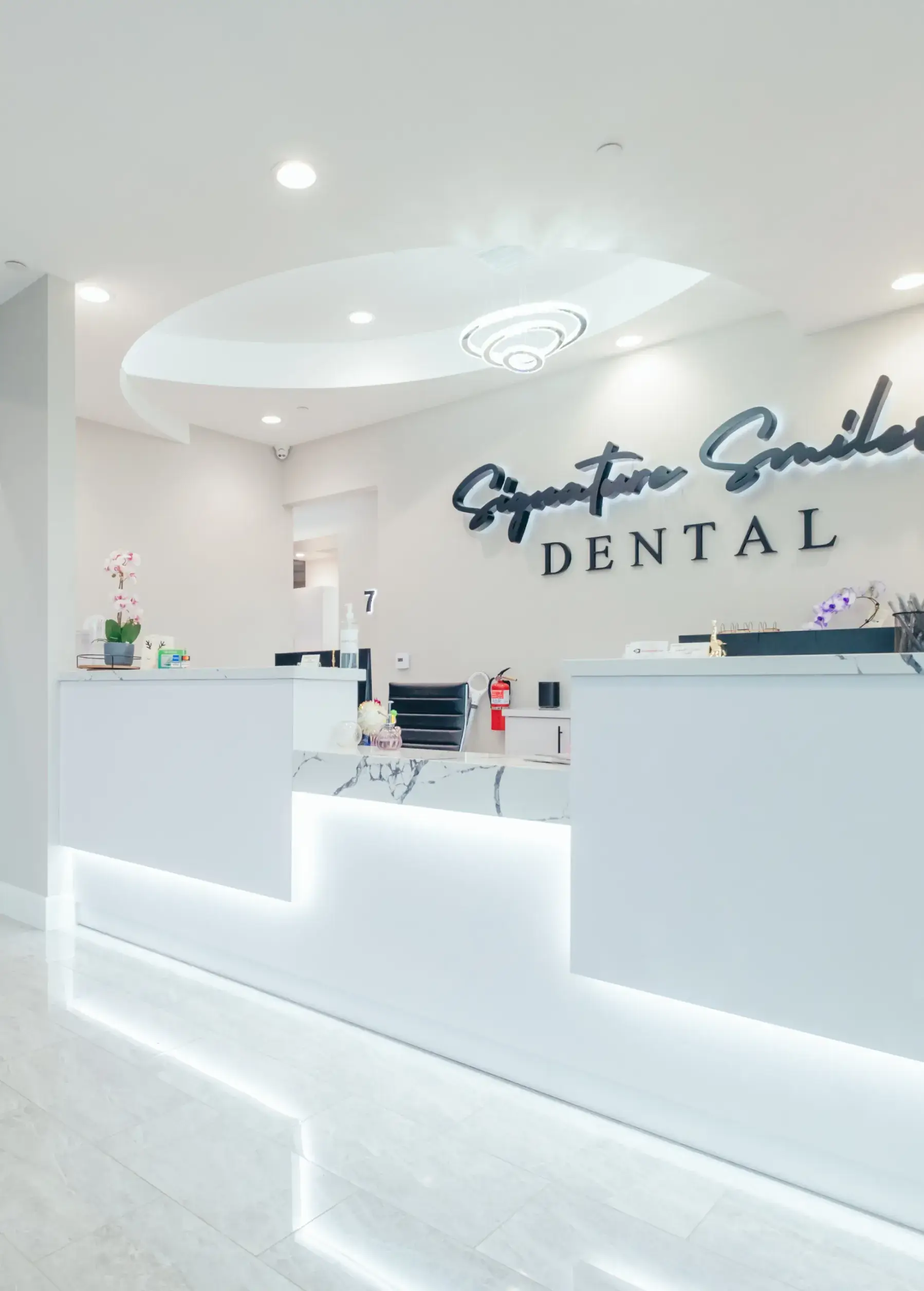 A dental office with a white counter and white walls.