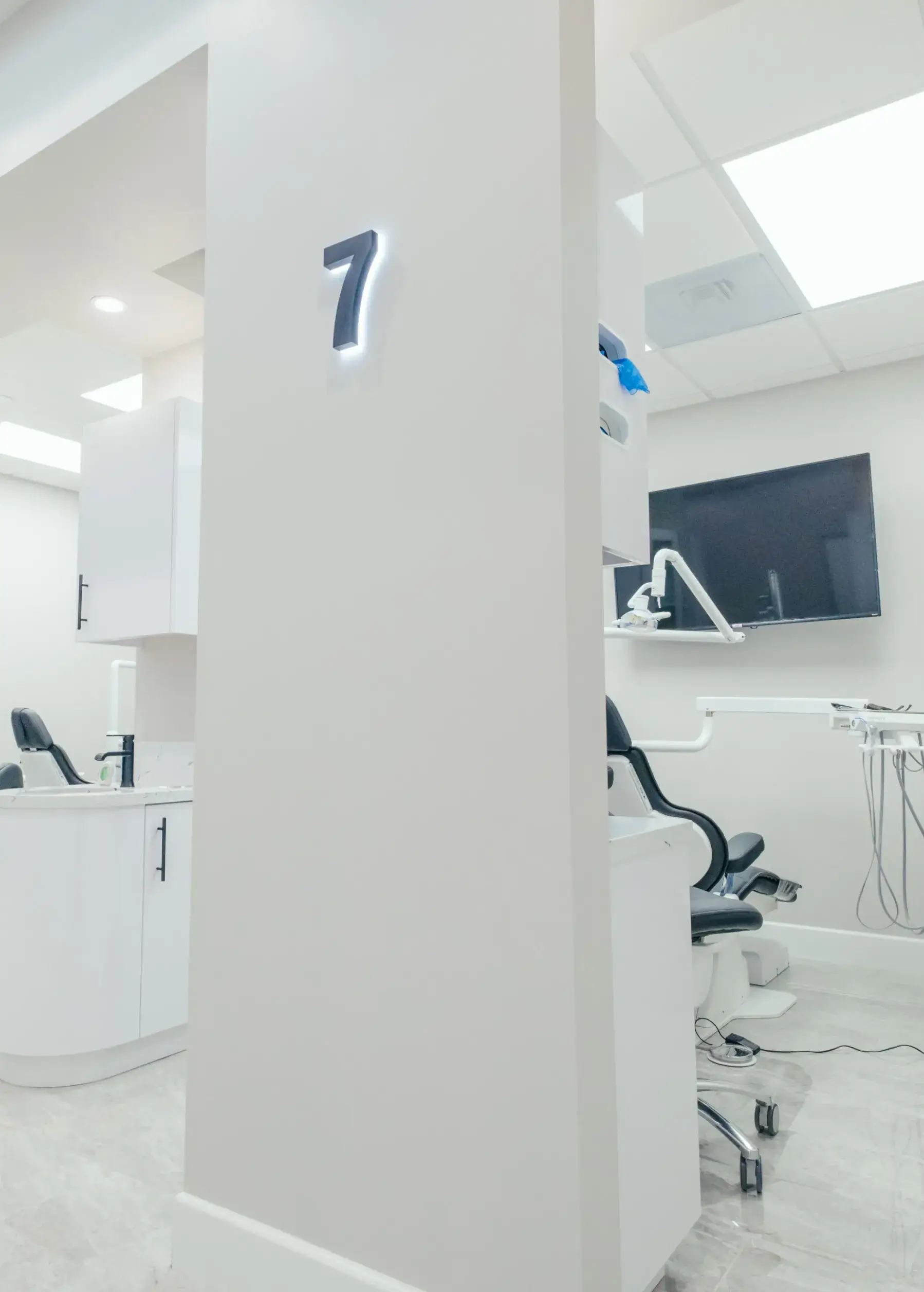 A white room with a number seven on the wall.