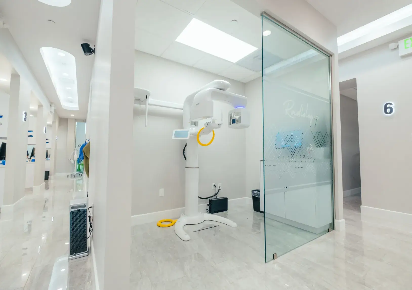 A white room with a large glass door.