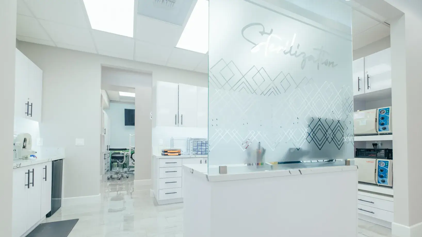 A kitchen with a white counter top and white cabinets.