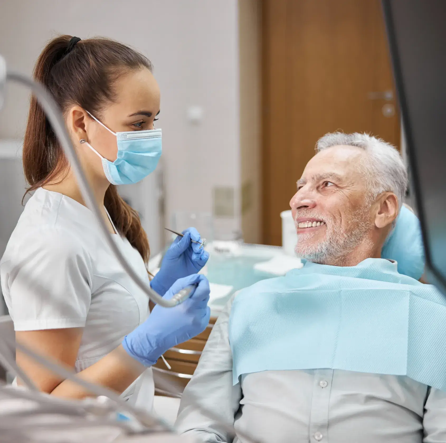 A man in a dentist chair getting his teeth checked.