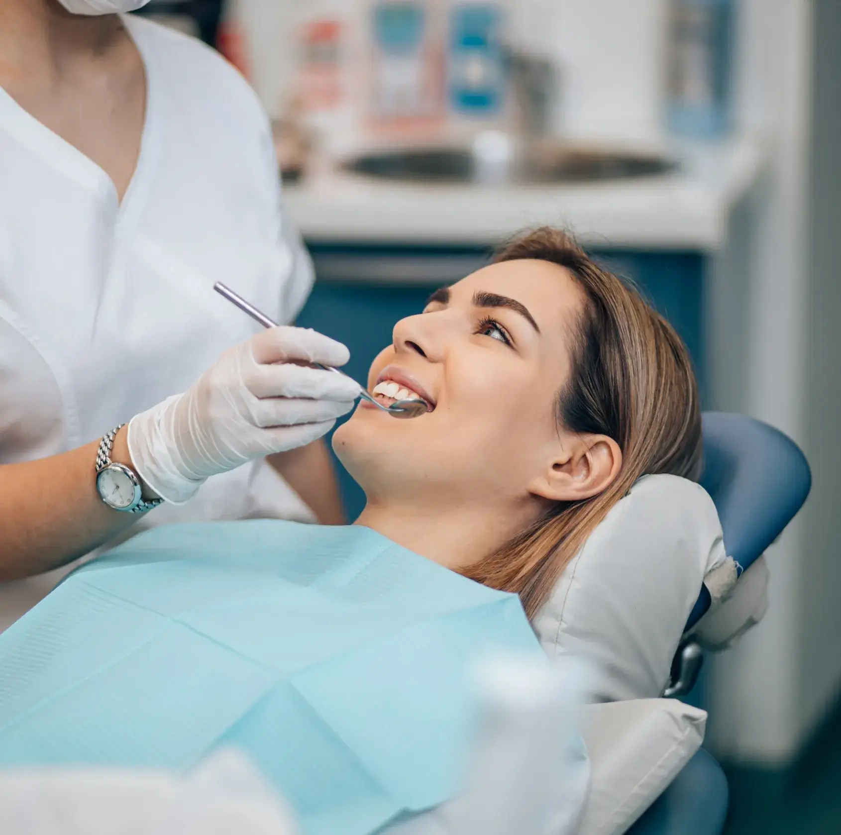 A woman getting her teeth checked by a dentist.