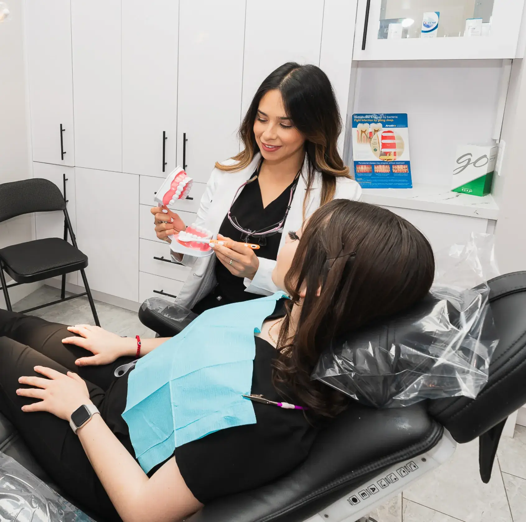 A woman sitting in a chair getting her hair done.