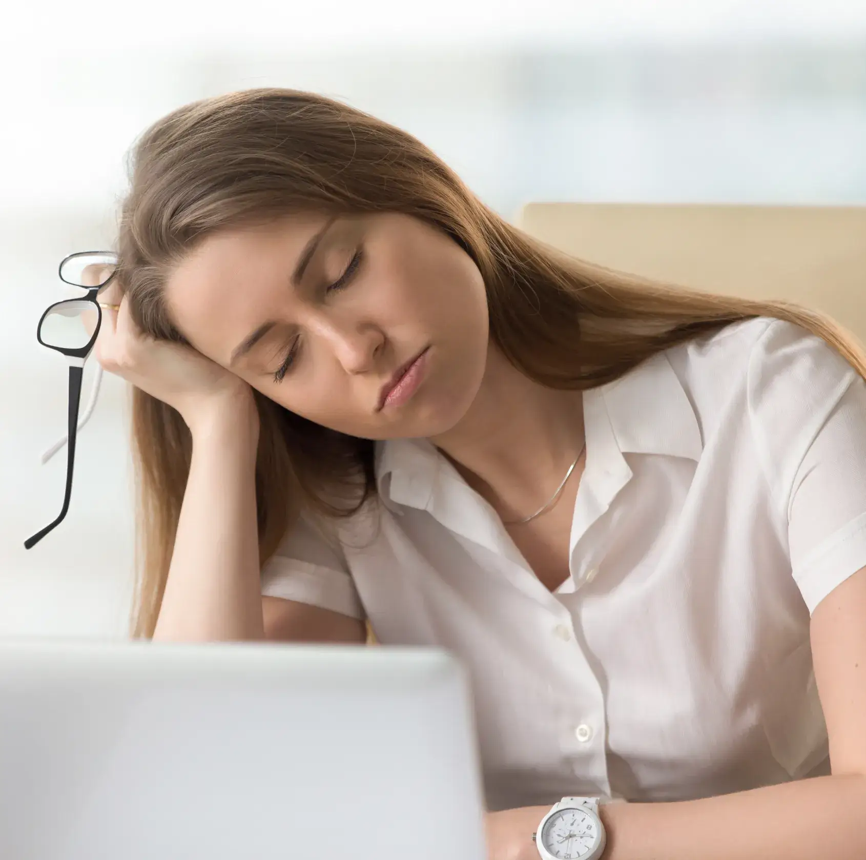 A woman sitting in front of a laptop computer.