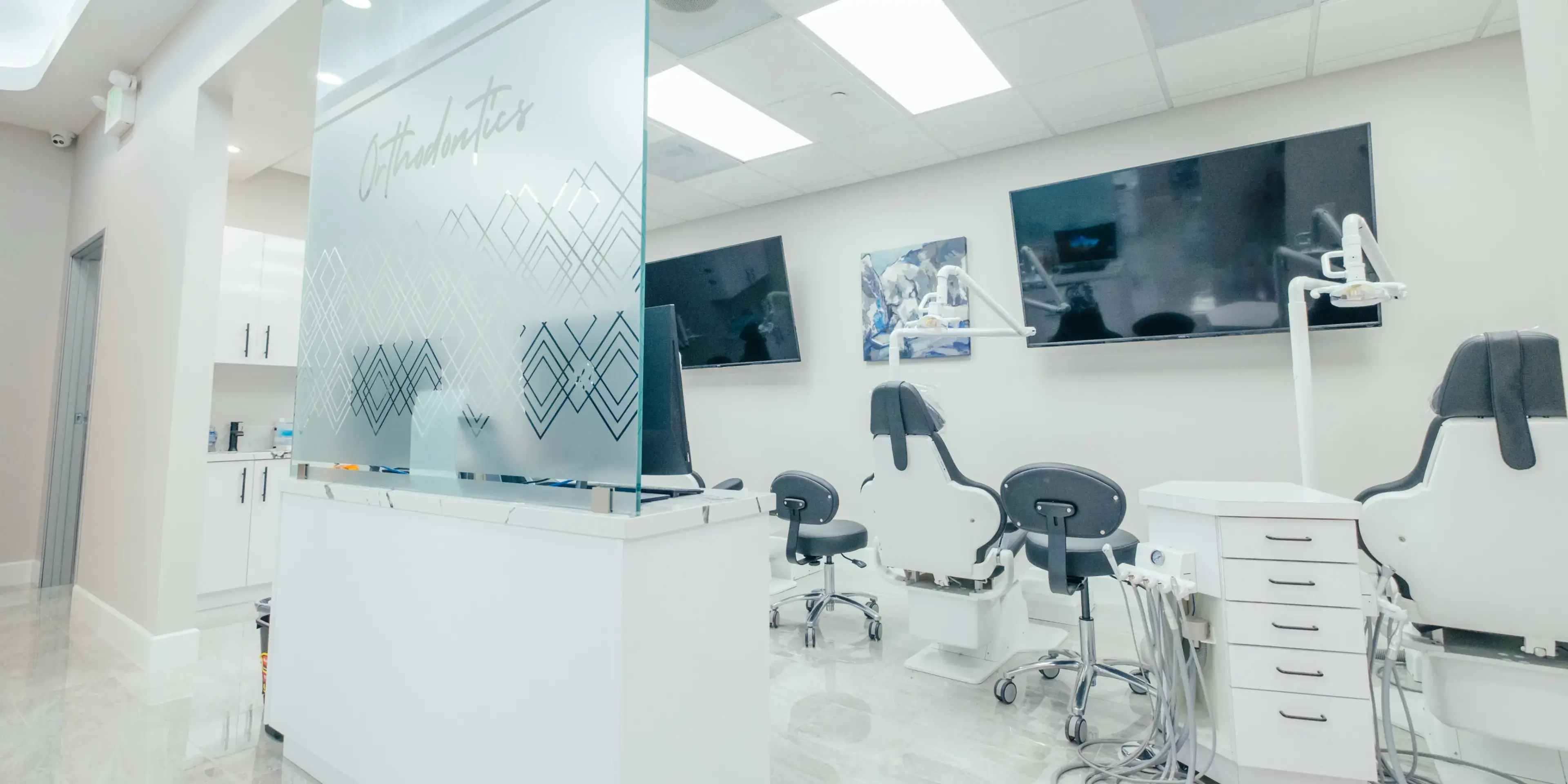A white room with chairs and pictures on the wall.