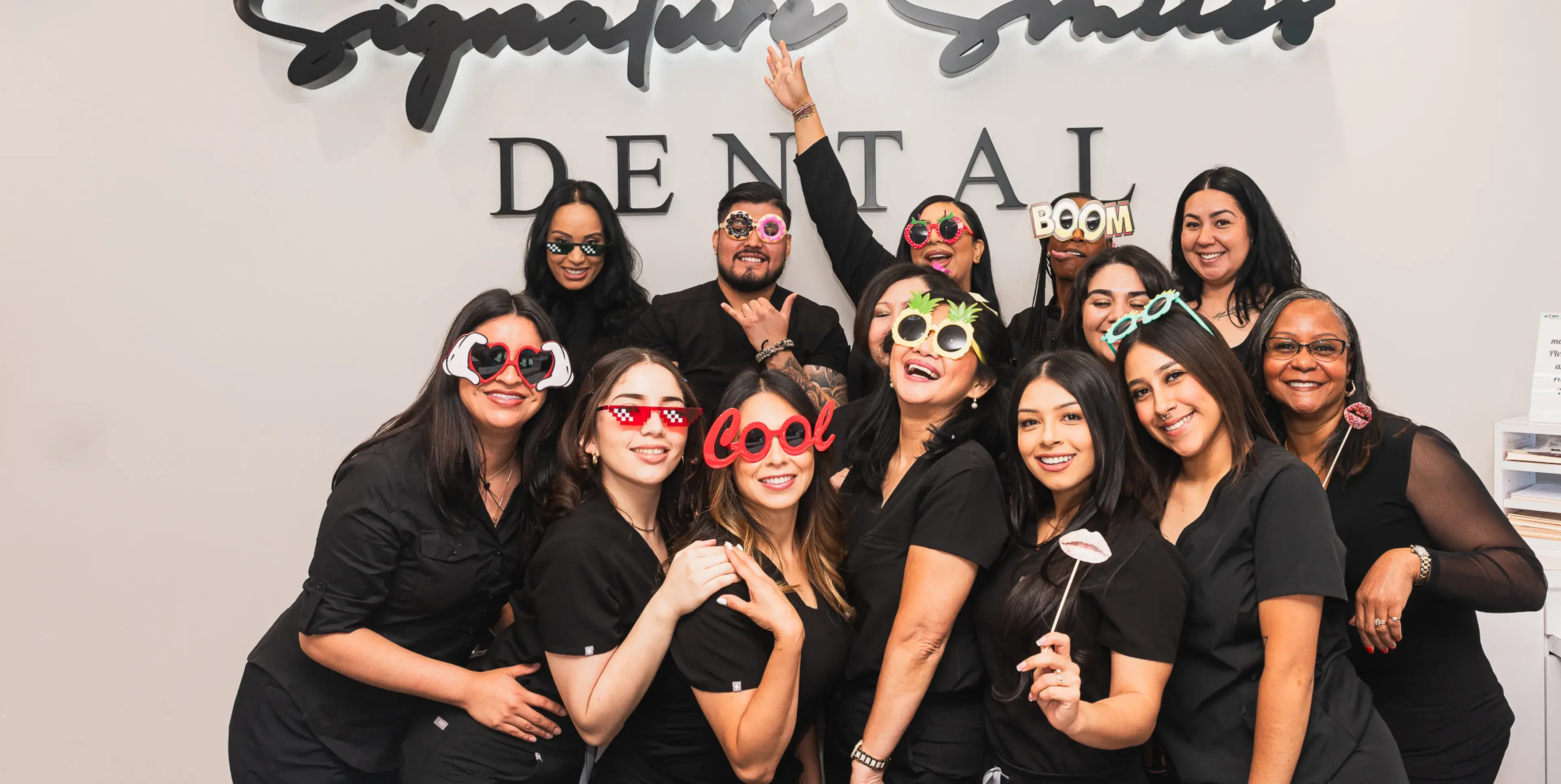 A group of people wearing masks posing for a picture.