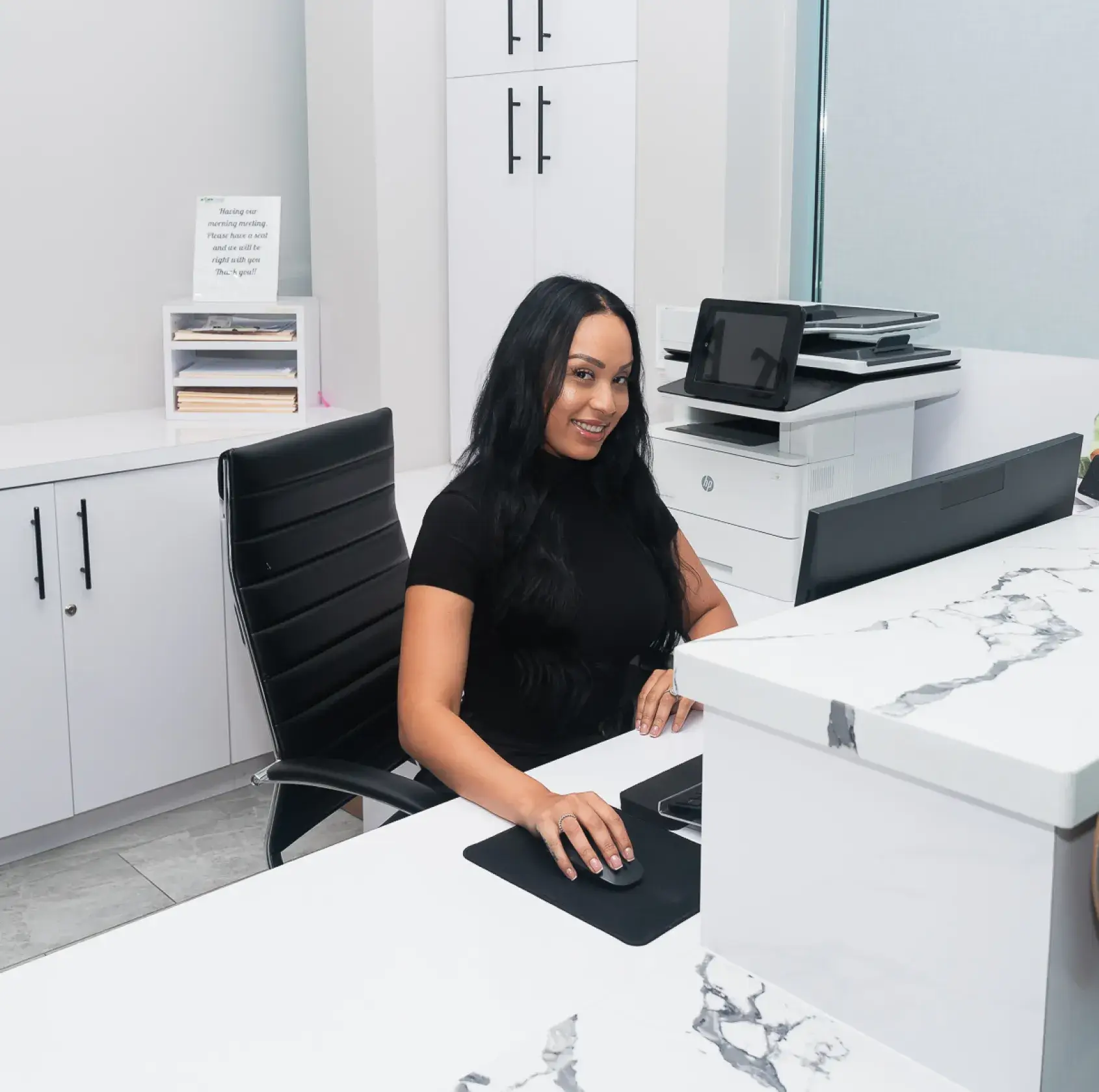 A woman sitting at a desk in an office.