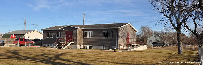 Exterior view of a gray office building associated with Fort Peck Community College’s Institutional Development Division, which supports strategic planning, grants management, and institutional growth initiatives.