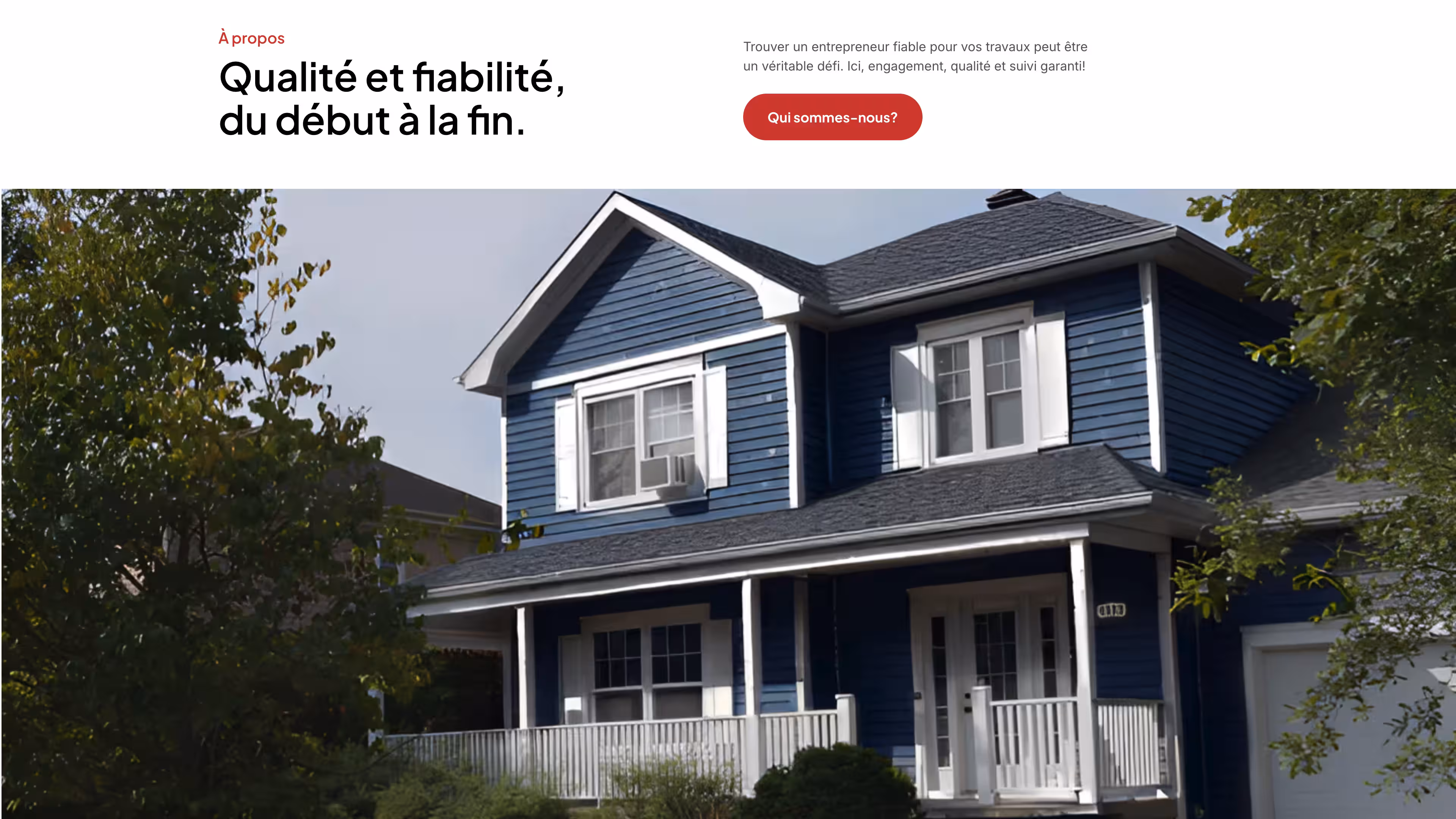 Blue two-story house with white trim, a front porch, and surrounded by green trees.