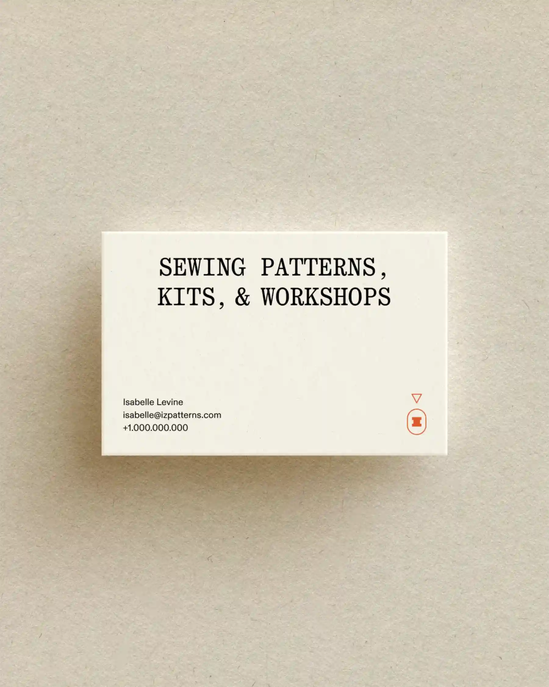 Izzie business card with text “Sewing Patterns, Kits, & Workshops” on neutral background