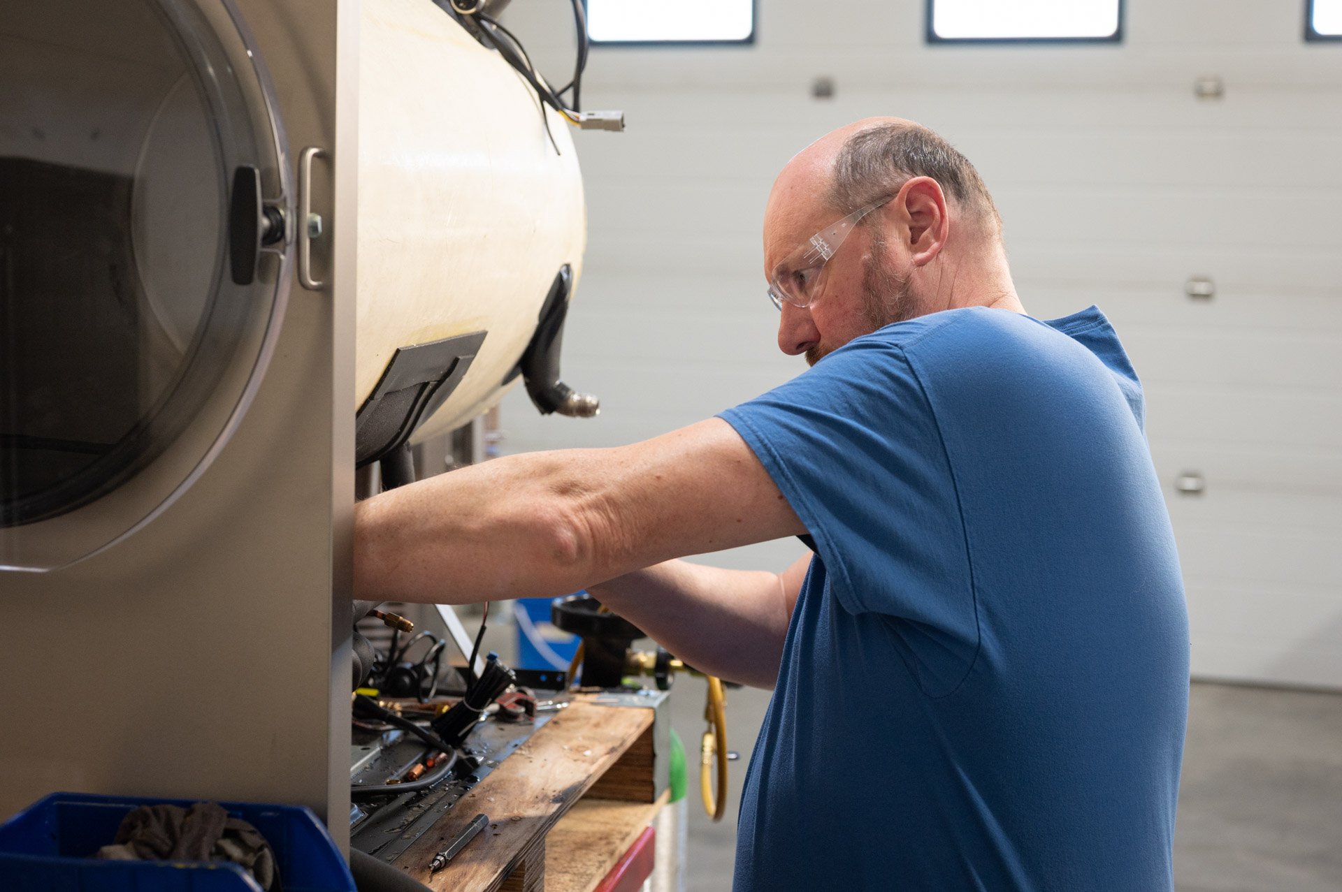 image of service technician working on the base of a freeze drying unit