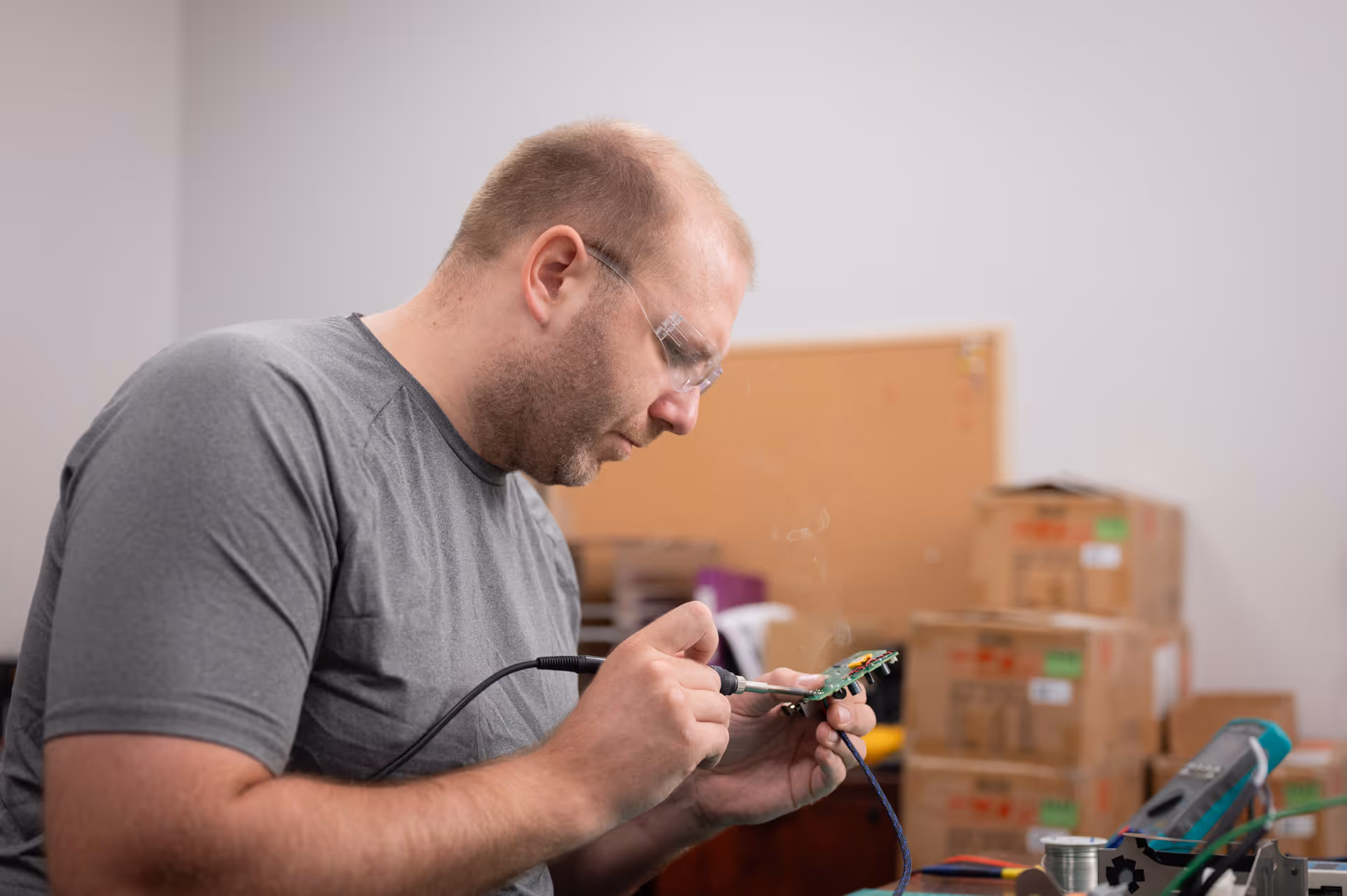 image of technician soldering a circuit board from a freeze dryer machine 