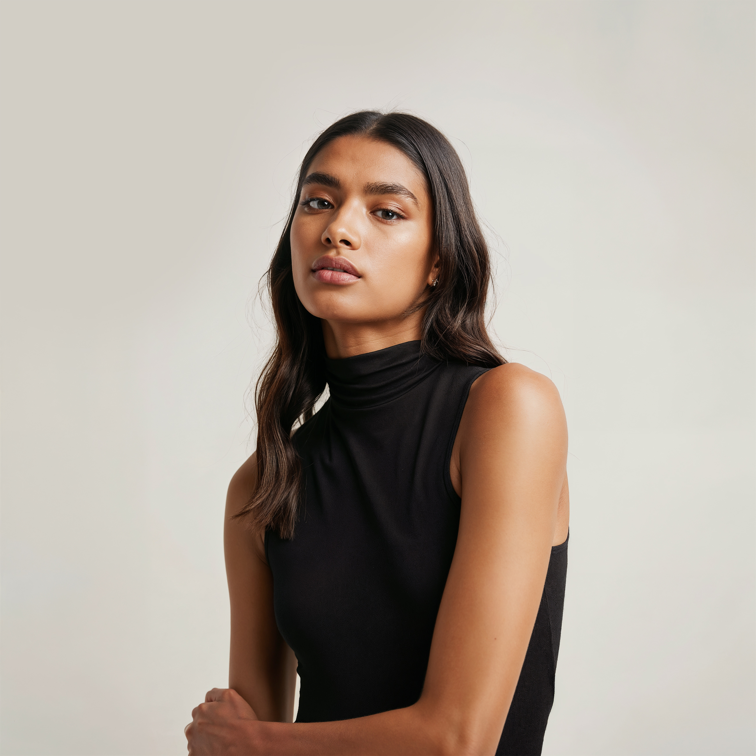 A woman in a black top with her arms crossed.