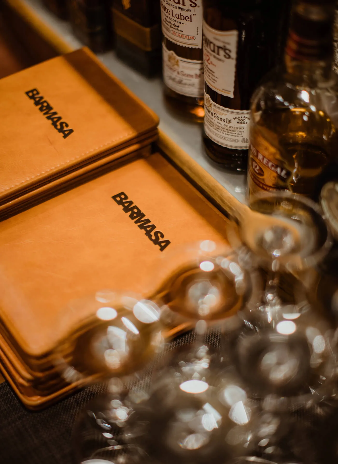 Menu's, glasses and alcohol bottles at partnering Bar Masa NYC,  neighboring Masa restaurant on the 4th Floor, 10 Columbus Circle, Time Warner Center, New York, NY 10019