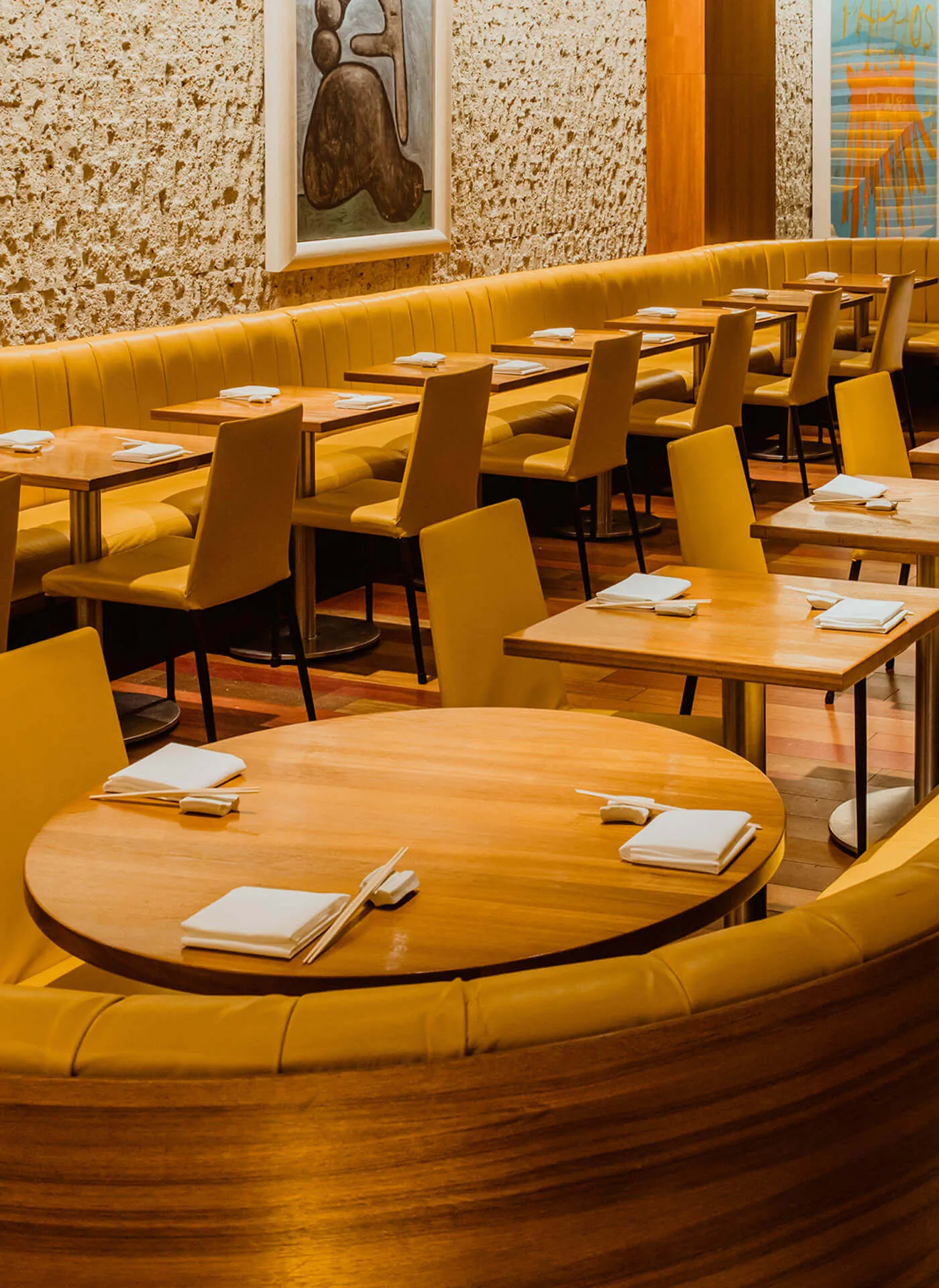 Round table in the main dining area of Kappo Masa restaurant, featuring more artwork from the Gagosian Gallery