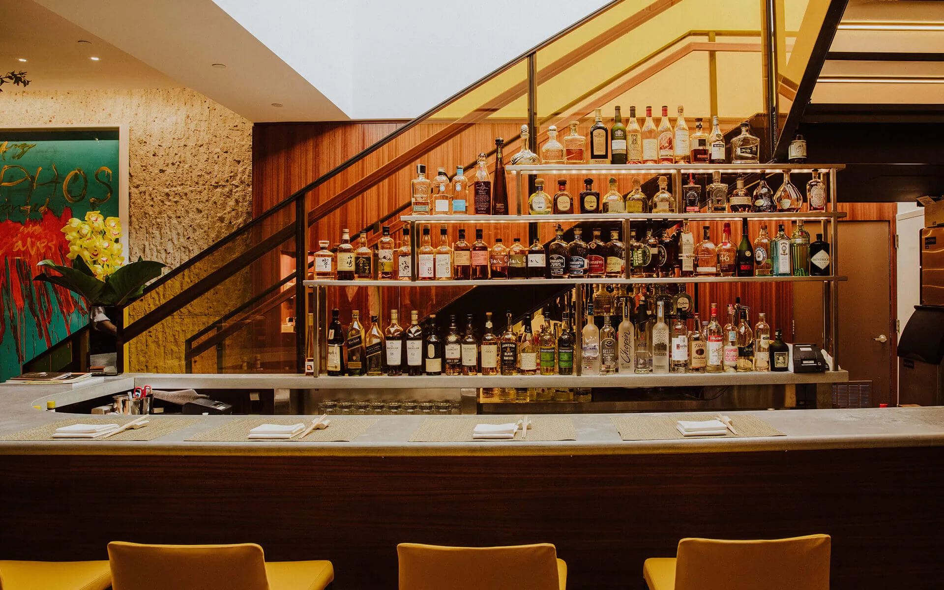 Wider shot of the bar, with staircase in the background.