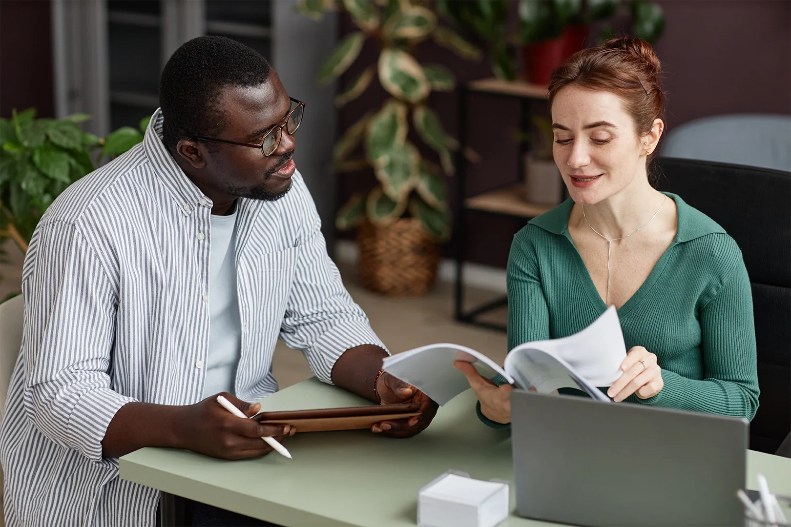 Two people having a discussion at a desk