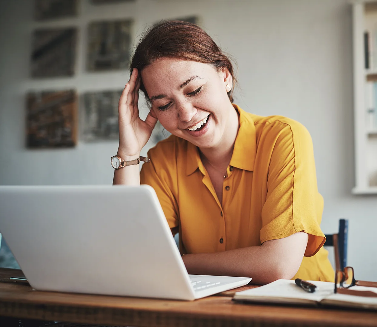 Woman looking relieved in front of a computer