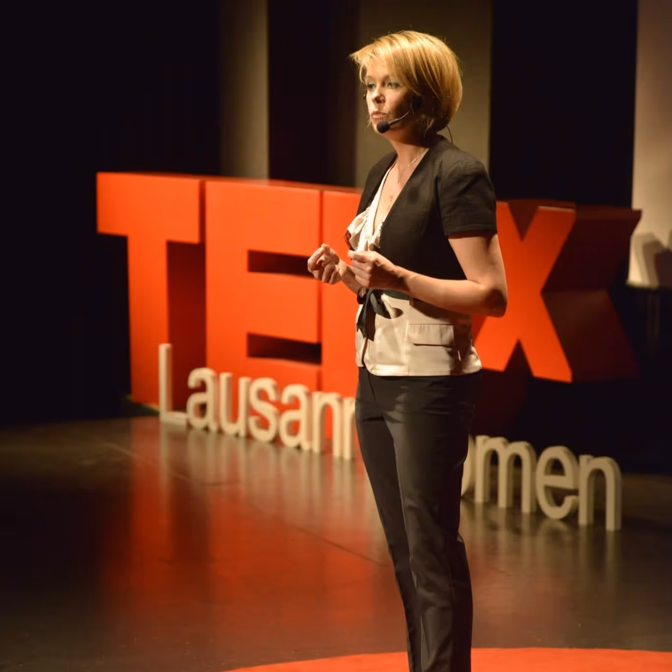 Sinikka Vuoti giving her ‘Moving Again’ TEDx talk on stage at TEDx Lausanne Women