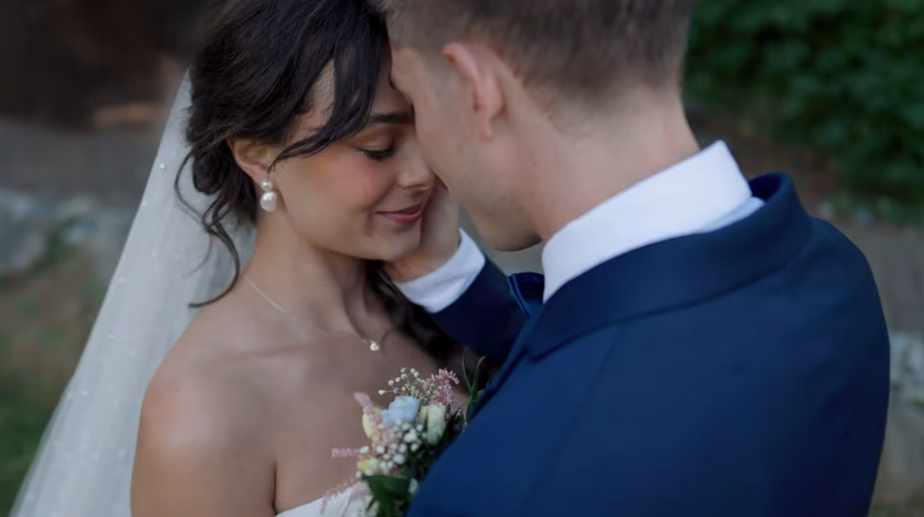 Bride and groom sharing a quiet, emotional moment outdoors — cinematic close-up from Tiffany and Brett’s elegant Canadian wedding film.