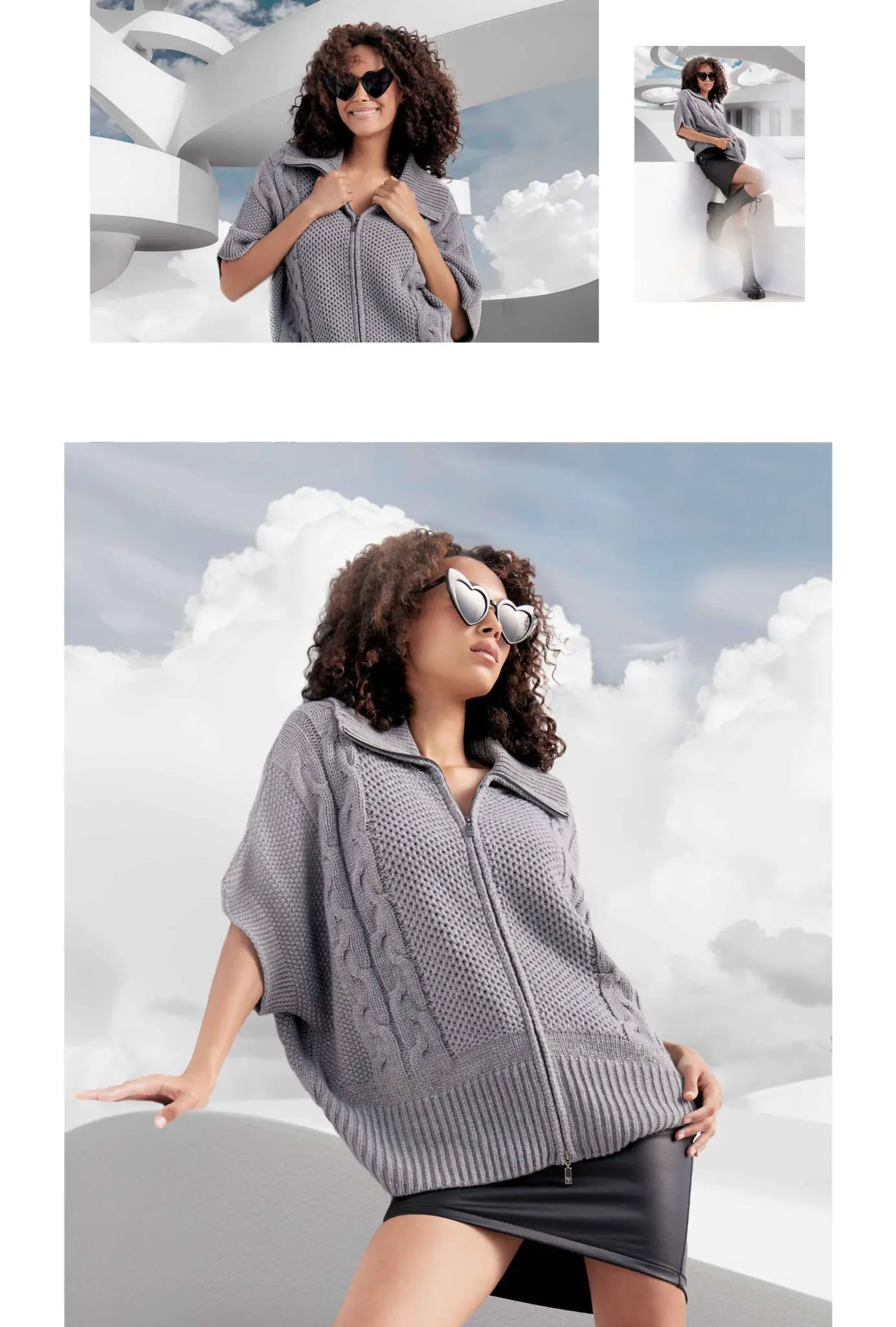 Woman wearing heart-shaped sunglasses, a gray knitted zip-up sweater, and a black skirt posing outdoors with white architectural structures and cloudy sky in the background.