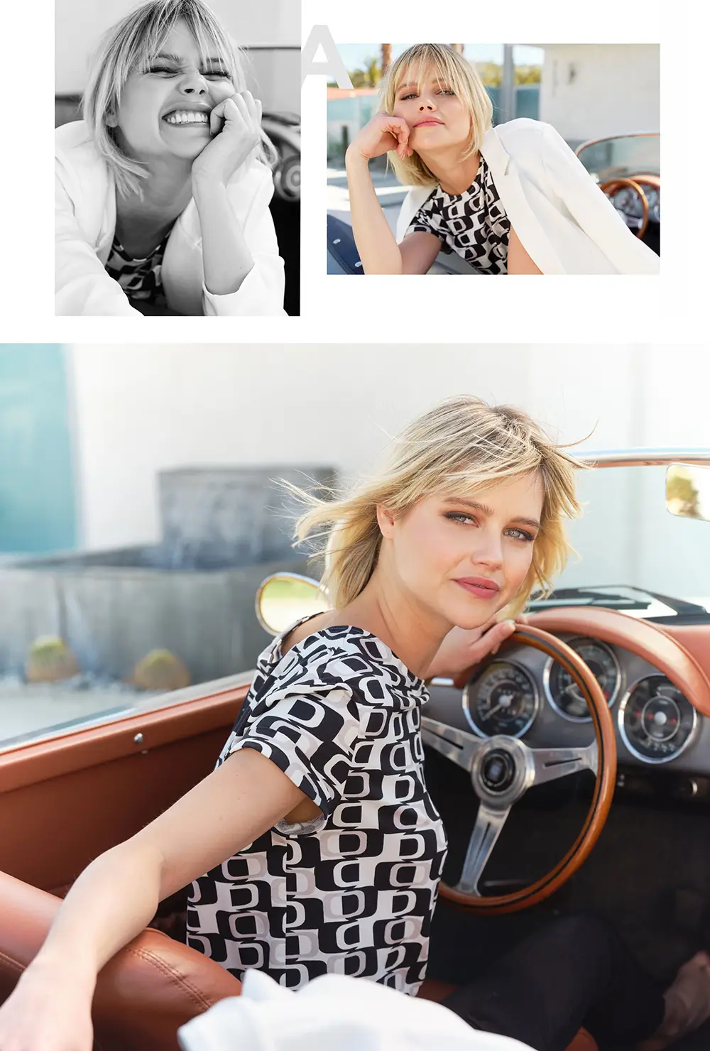 Blonde woman wearing a patterned shirt and white blazer, smiling in a black and white portrait, posing outdoors resting her chin on her hand, and sitting in a vintage car holding the steering wheel.