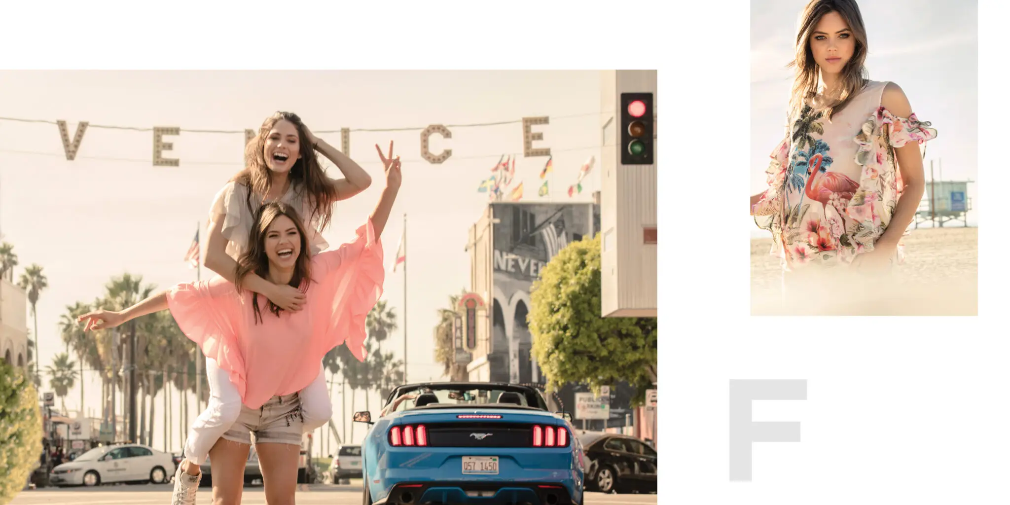 Two smiling young women, one giving the other a piggyback ride on a sunny street with palm trees and a blue Mustang convertible near a Venice Beach sign.