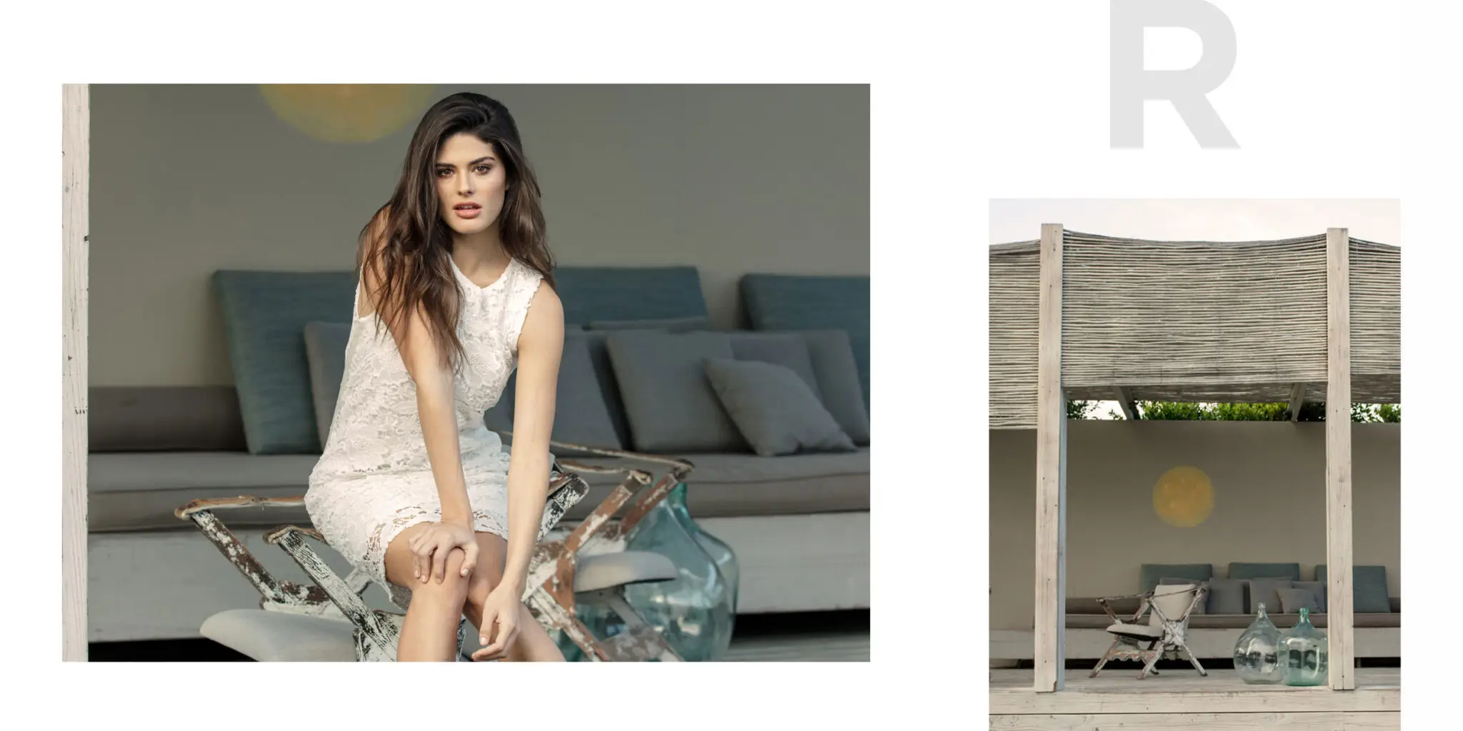 Woman in a white lace dress sitting on a rustic chair on a porch with gray cushions and large glass jars nearby.